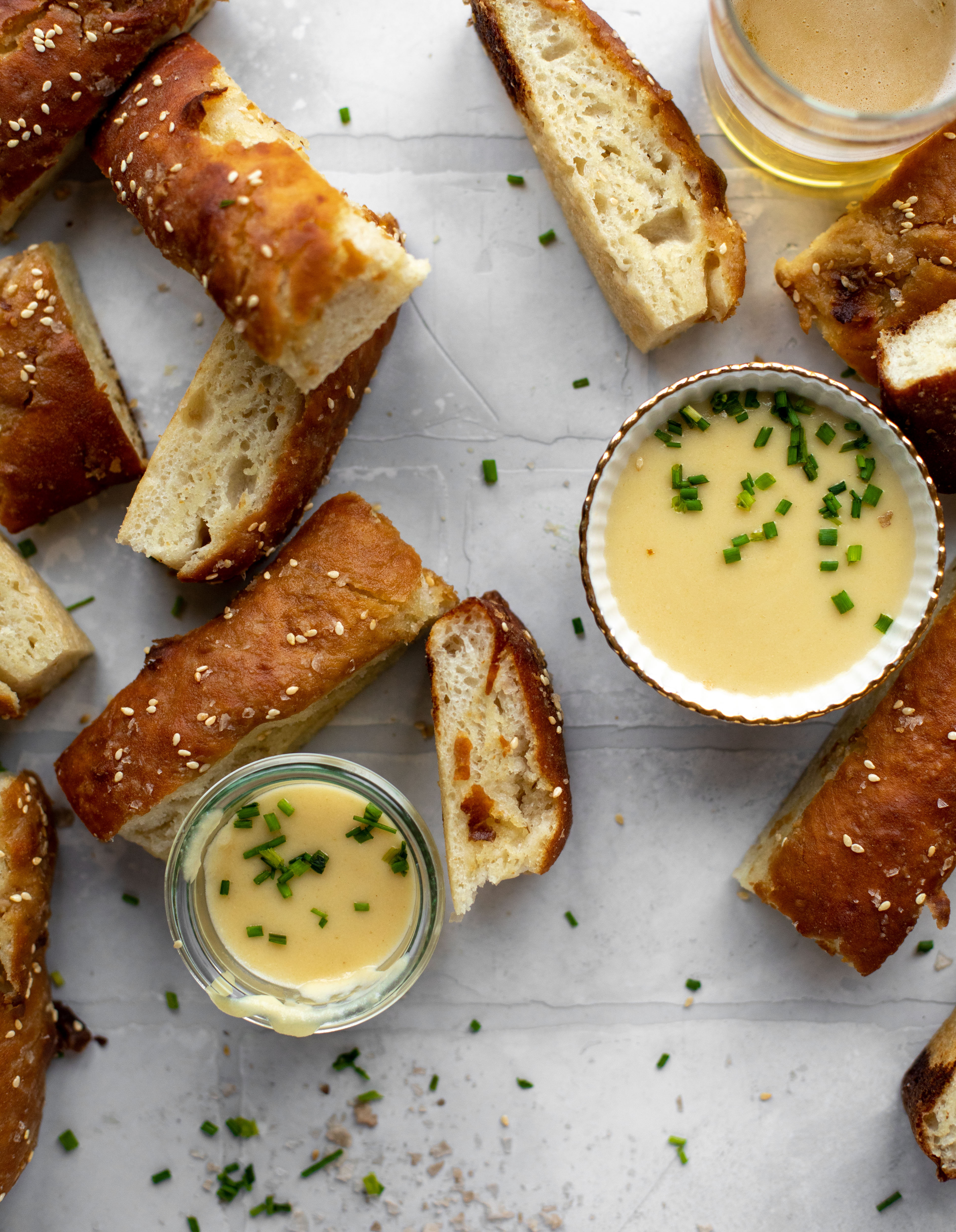 This sesame pretzel focaccia bread is amazing! Almost like a soft pretzel with crispy edges. Serve with a delicious dijon beer cheese.
