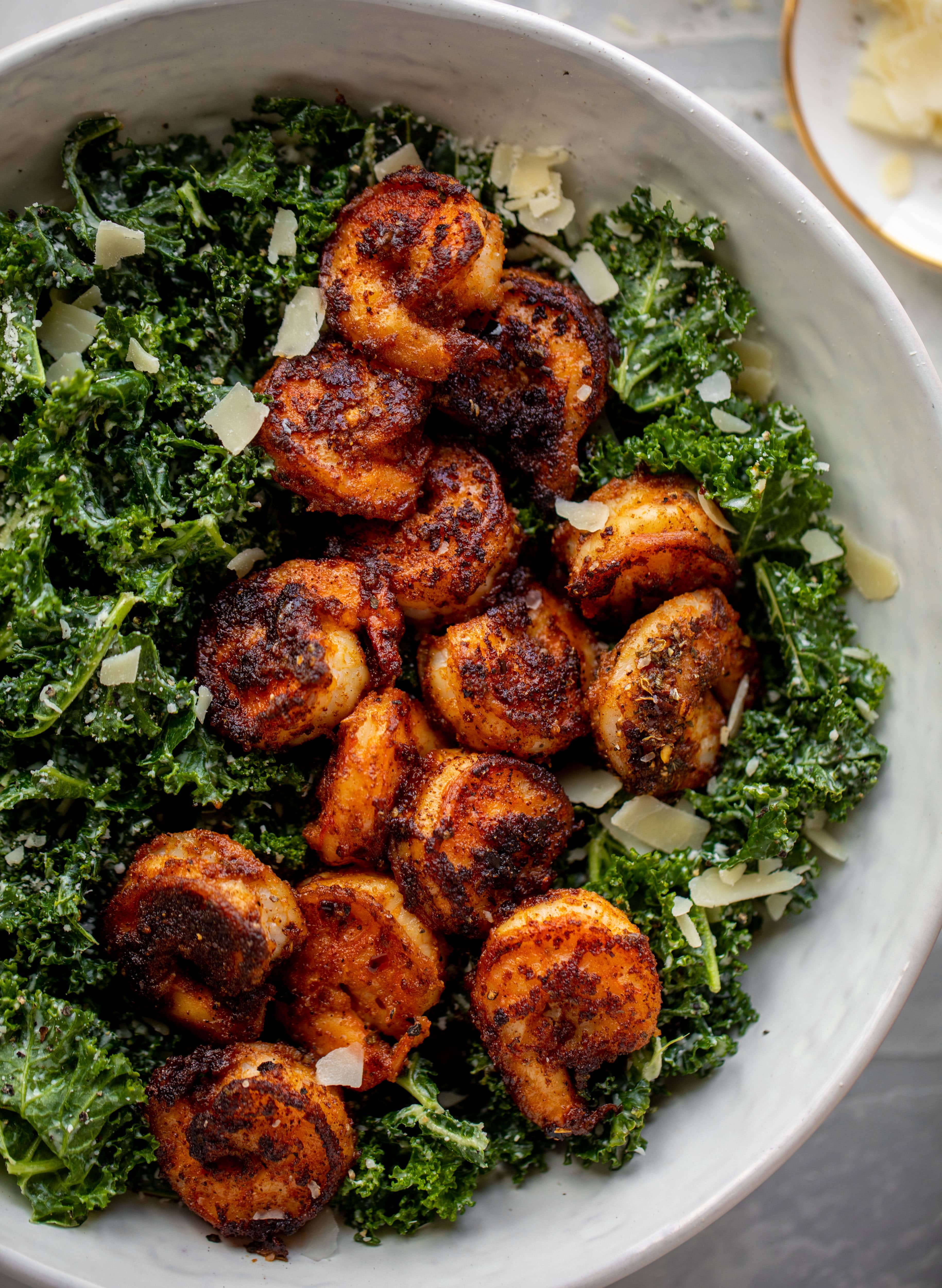 This blackened shrimp kale caesar is loaded with flavor. Spiced, buttery shrimp pan fried until golden, then thrown on kale caesar salad. Delish!