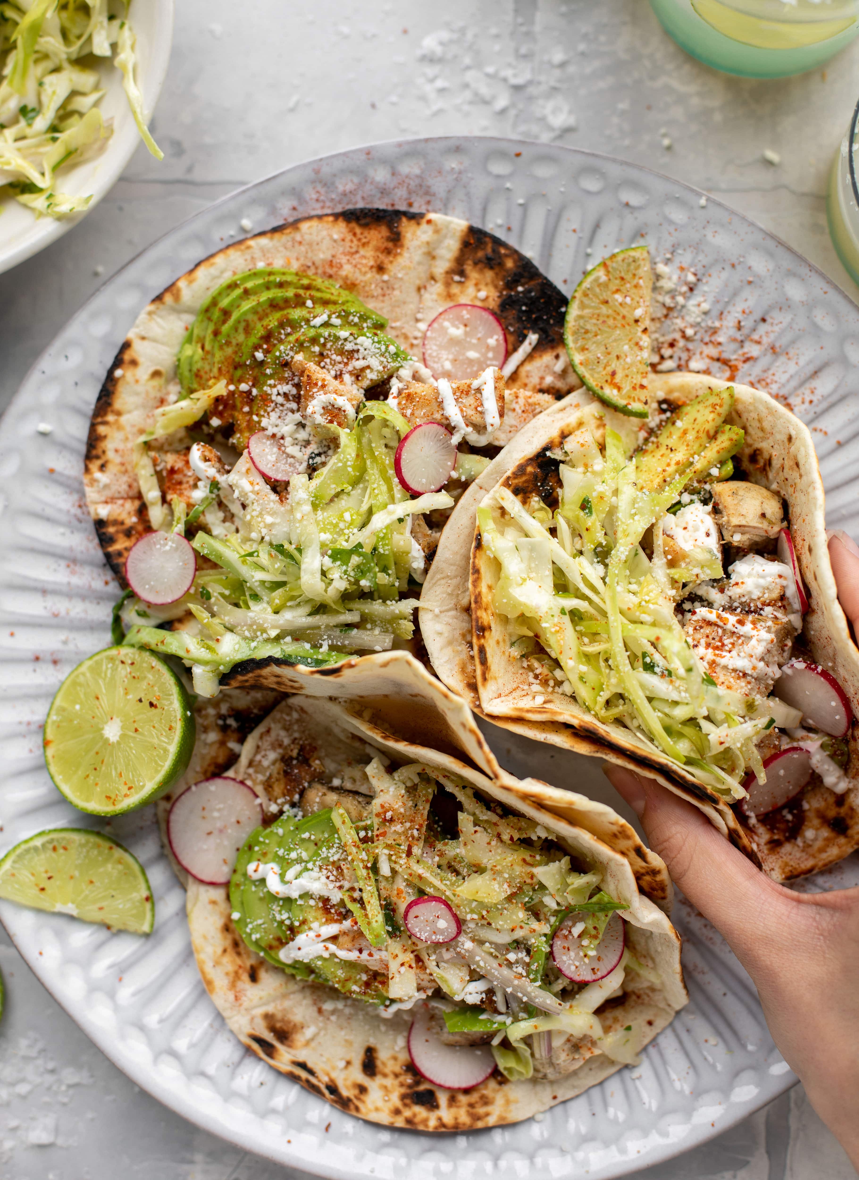 These grilled chicken tacos are easy and flavorful. They are super smoky, then topped with a key lime slaw that is absolutely delicious!