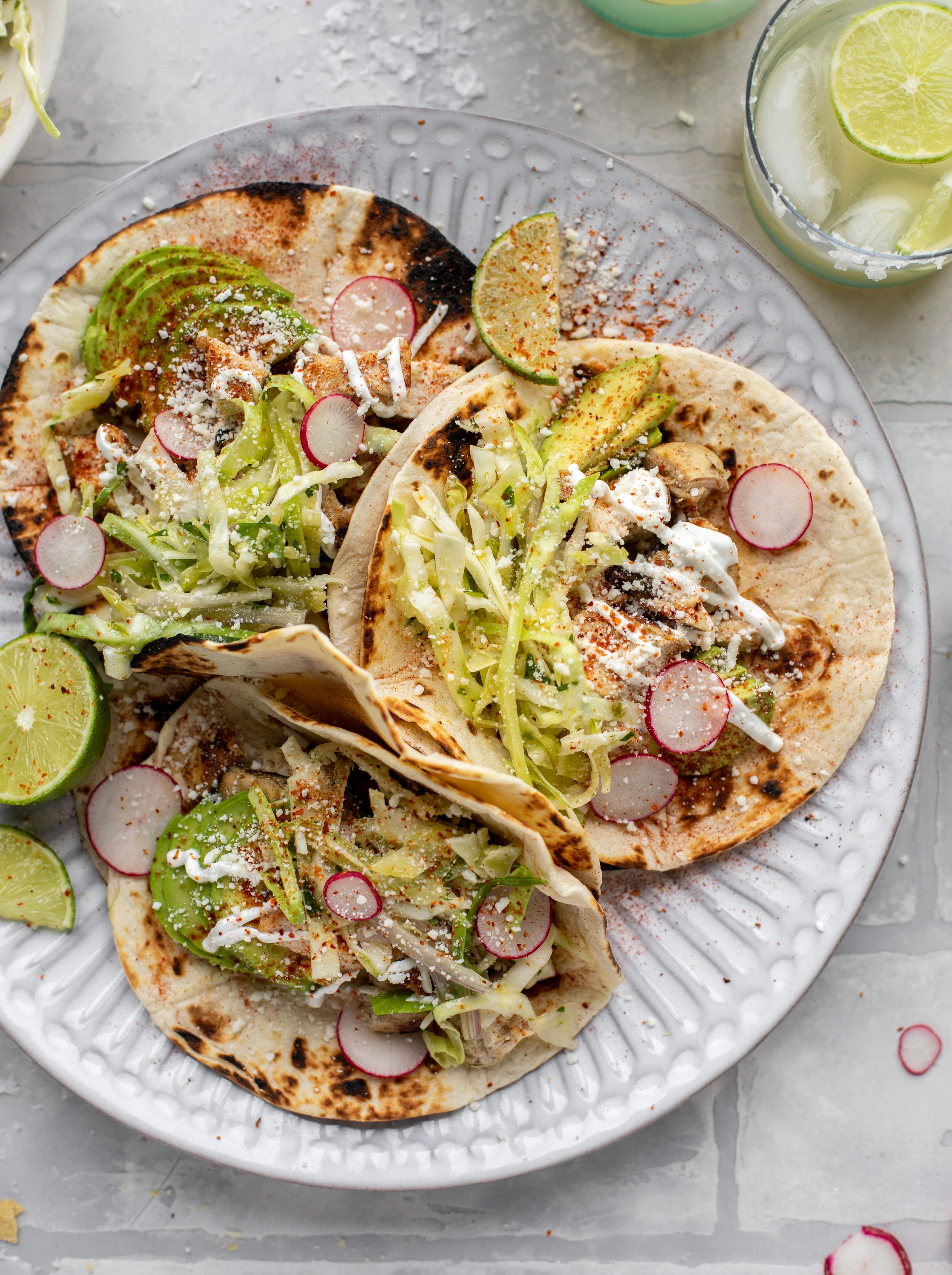 These grilled chicken tacos are easy and flavorful. They are super smoky, then topped with a key lime slaw that is absolutely delicious!