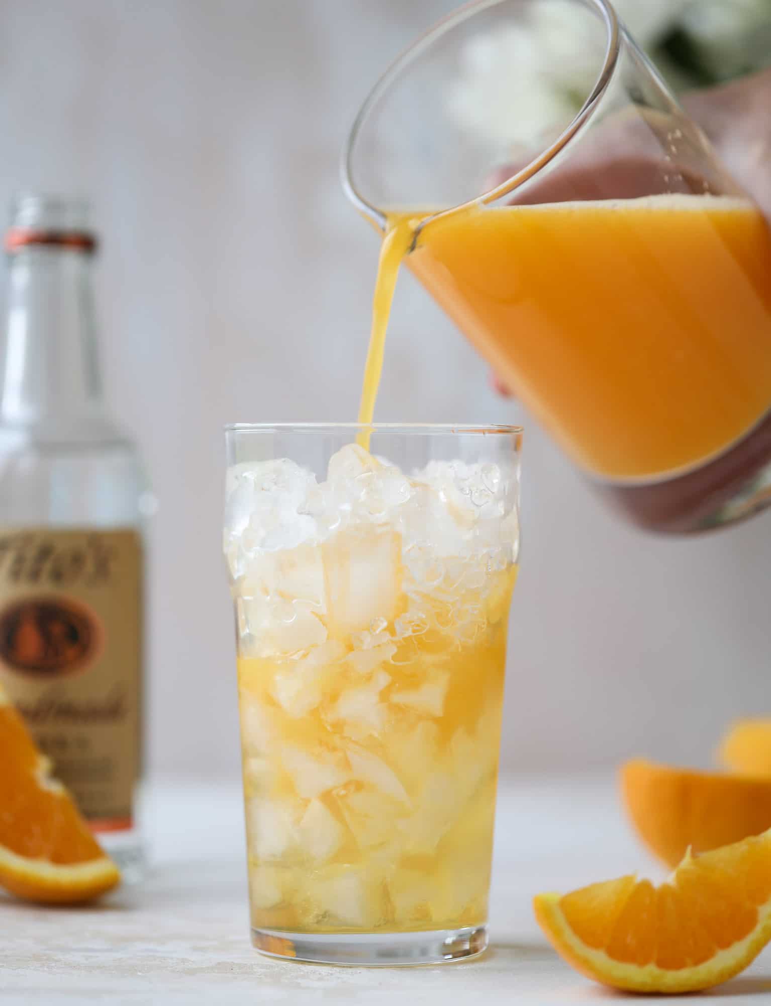 This orange crush is a copycat cocktail from the ones served in Ocean City, Maryland at the beach all summer long! It's one entire freshly squeezed orange with vodka and lemon lime soda and it tastes like heaven. Super refreshing and perfect for summer. I howsweeteats.com #orange #crush #cocktail #ocean #city #vodka