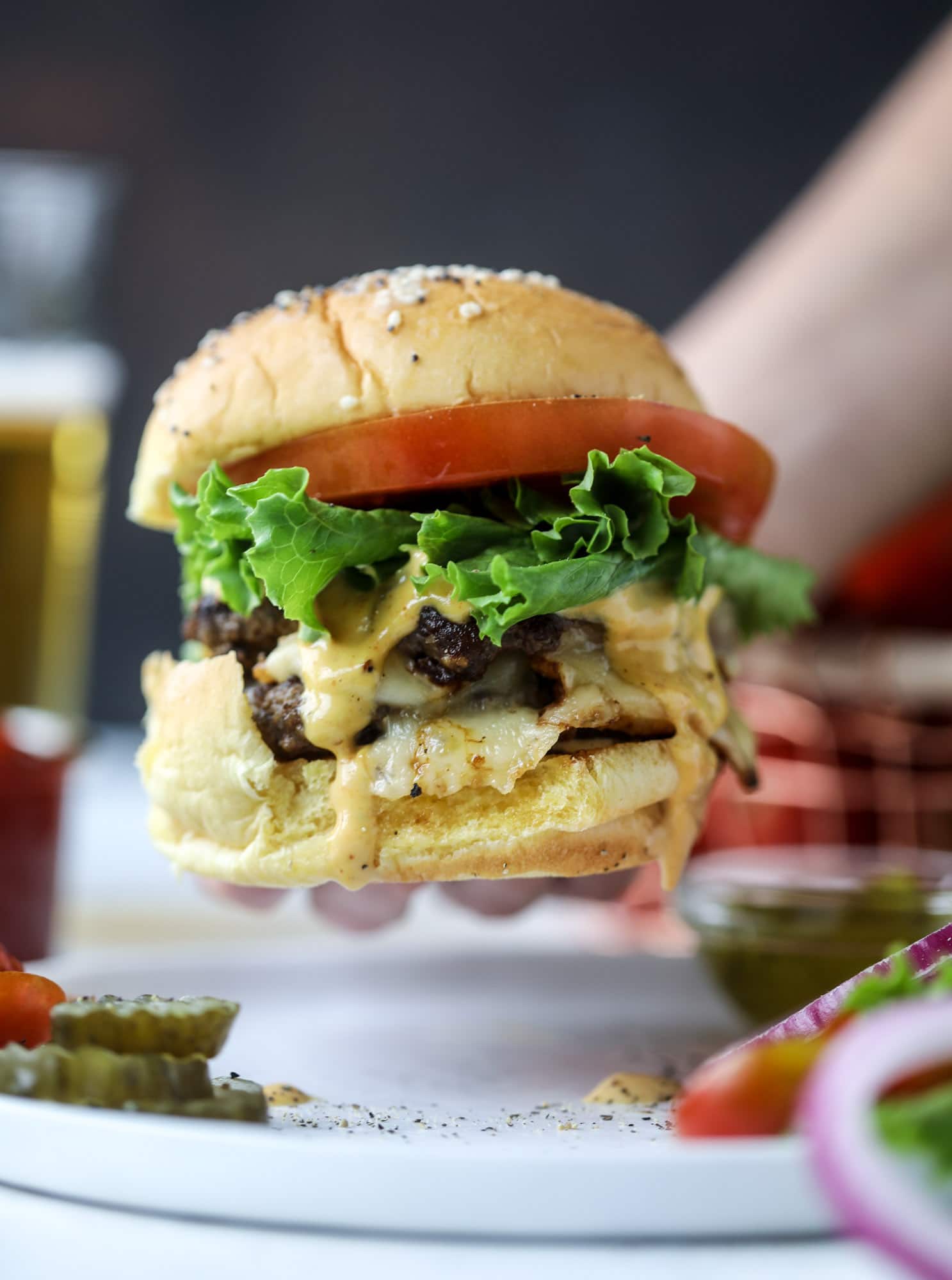 These smash burgers are to die for! All you need are a few ingredients and 30 minutes to make these smash burgers happen. Topped with melty smoked gouda and topped with a creamy, tangy house sauce, these are the best burgers ever! I howsweeteats.com #smash #burgers #smoked #gouda #special #sauce