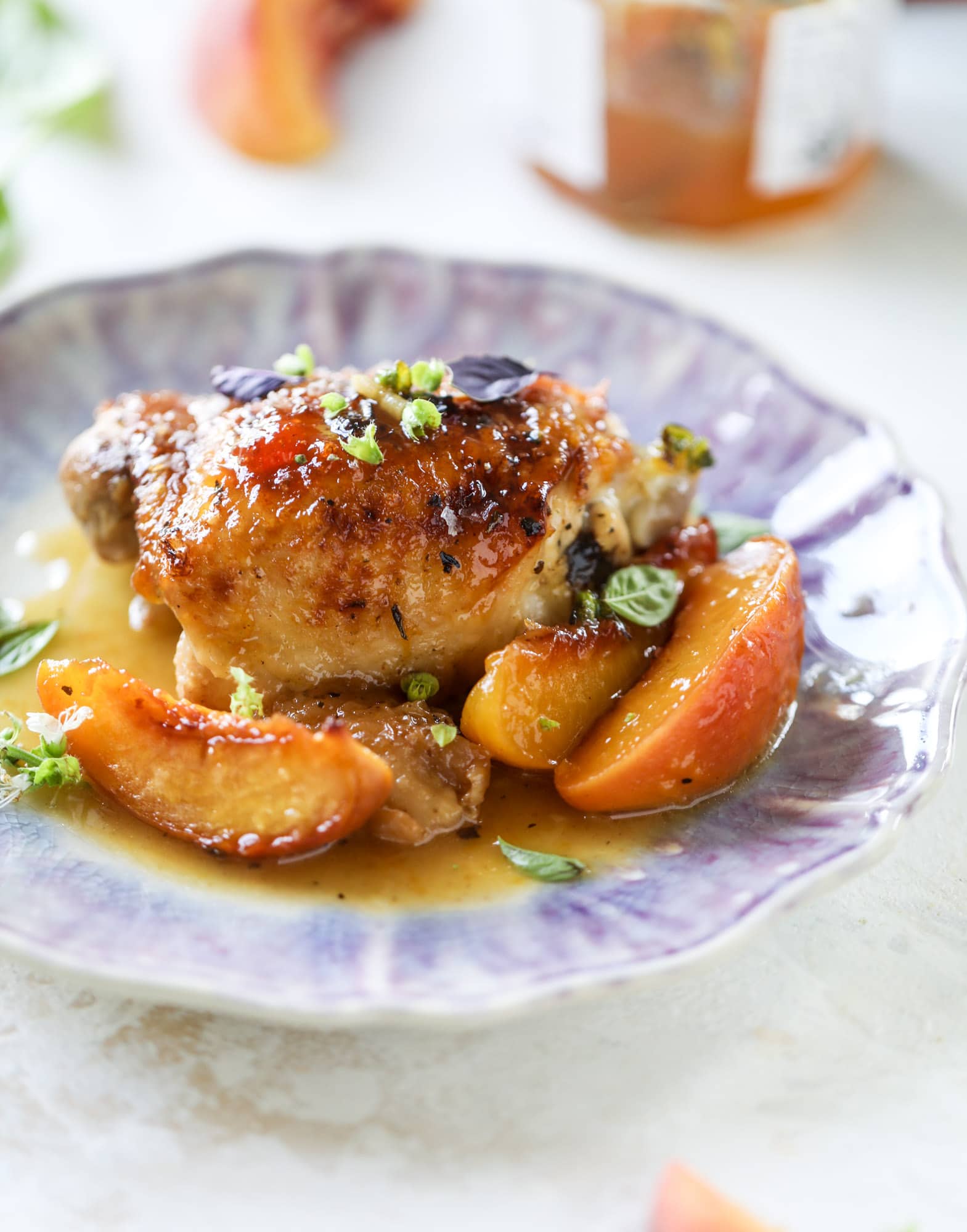 This amazing summertime one pot chicken is made with fresh peaches and basil and takes no time at all. The sweet and savory combination is perfect for a quick weeknight meal; the sauce is amazing for dipping and the chicken is flavorful as can be. I howsweeteats.com #chicken #peach #basil #easy #dinner #recipe #summer #healthy