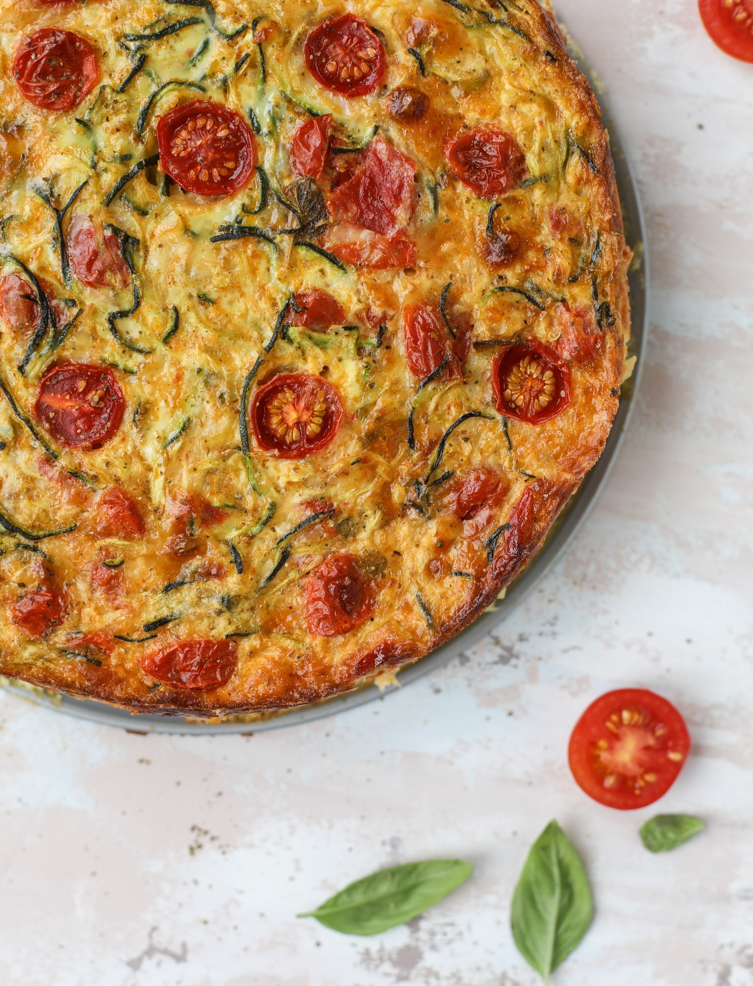 This zucchini pie recipes is absolutely divine and perfect for breakfast or dinner! Completely with garlic and blistered tomatoes, it combines cheese and egg to make a to-die-for frittata-like dish that can be eaten hot or cold! I howsweeteats.com #zucchini #pie #tomatoes #eggs #recipes #garden #summer