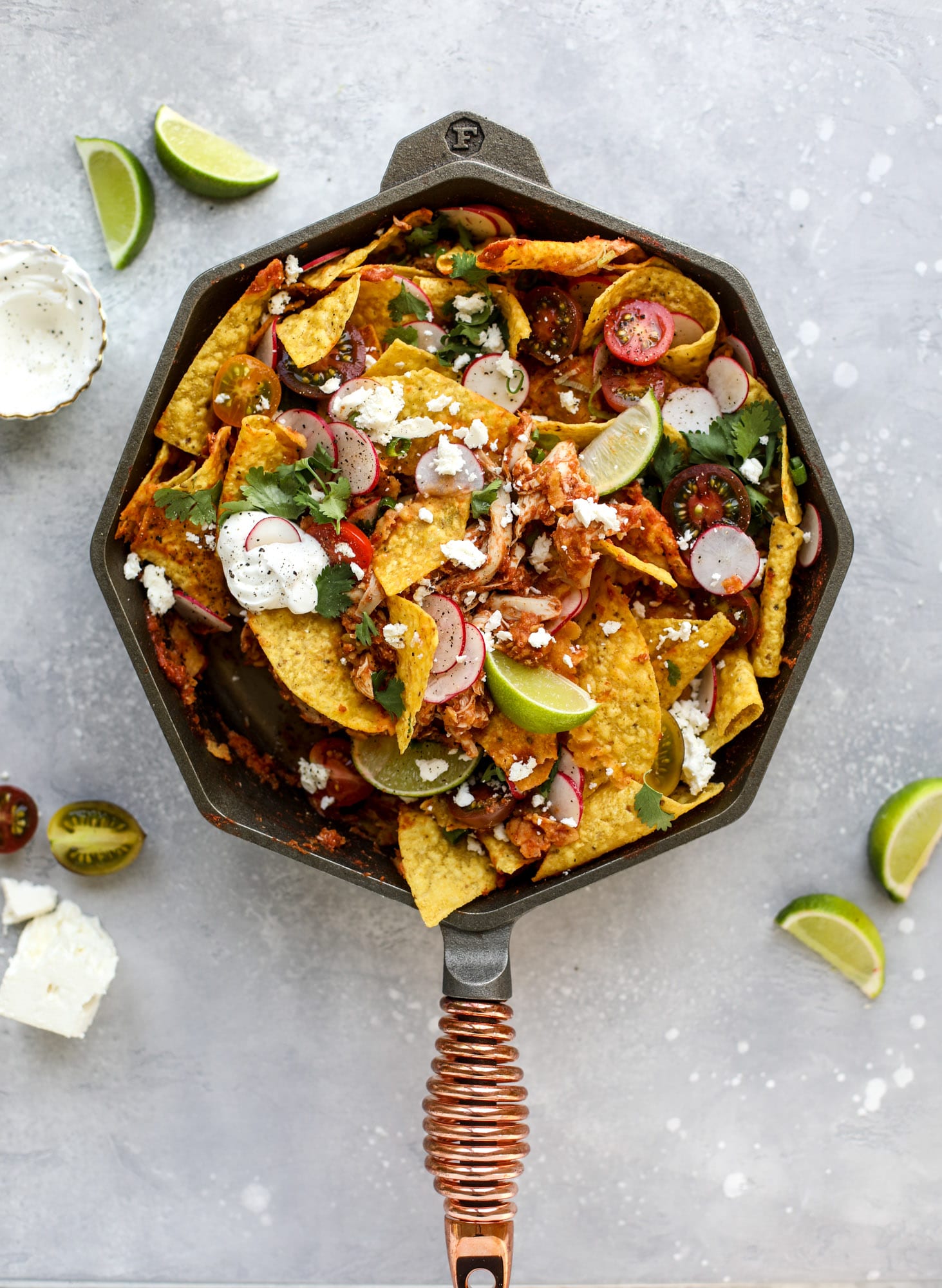 This skillet of fire roasted chicken chilaquiles is so easy, flavorful and delicious! A quick blender sauce made with fire roasted tomatoes, shredded chicken, lots of tortilla chips and your favorite toppings. Give me all the cheese and guacamole! I howsweeteats.com #chicken #chilaquiles #recipe #easy #dinner