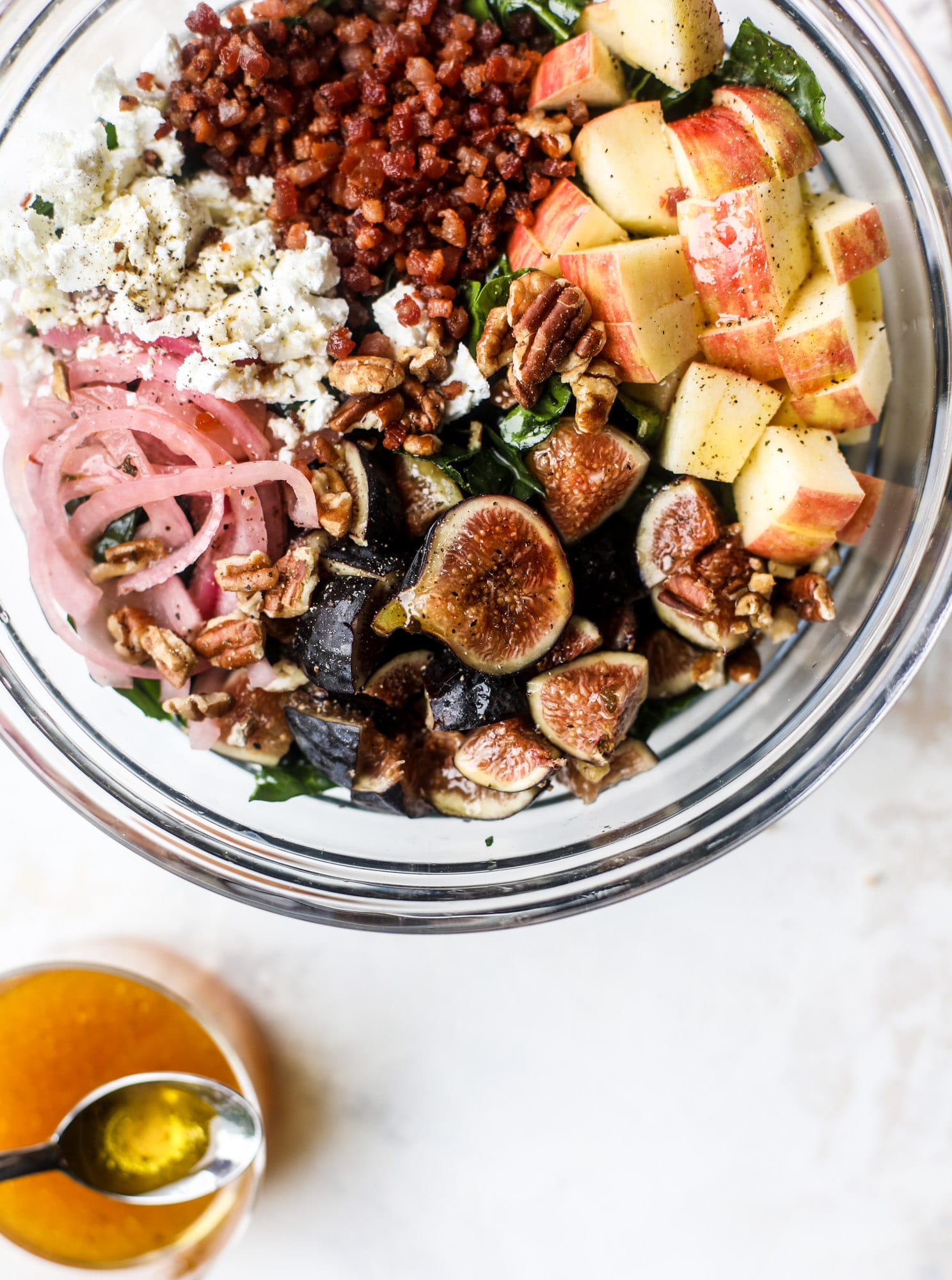 This fall kale salad is perfect for the season and full of so much delicious flavor! Shredded kale, honeycrisp apple, fresh figs, pancetta, pickled onions, pecans and goat cheese come together with a maple cider vinaigrette for salad heaven. I howsweeteats.com #fall #kale #salad #apples #figs #pecans