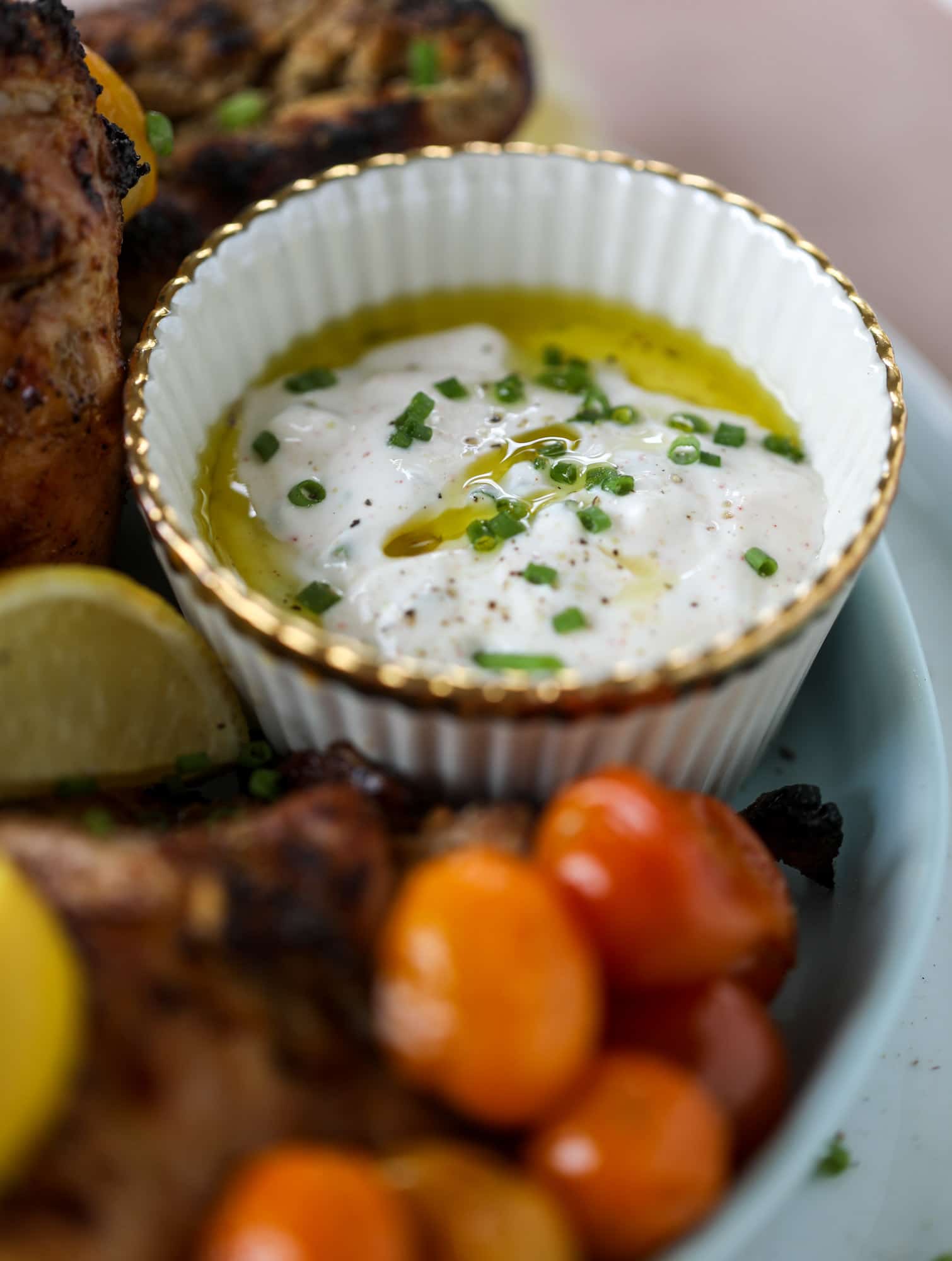 This yogurt marinated chicken recipe is super flavorful, tender, juicy and delicious. The fresh lemon adds a kick of flavor and it's a versatile recipe you can make for lunch or dinner. Grill it and serve with your favorite side, then use the leftovers for lunch! I howsweeteats.com #yogurt #chicken #lemon #grilled #healthy #recipes