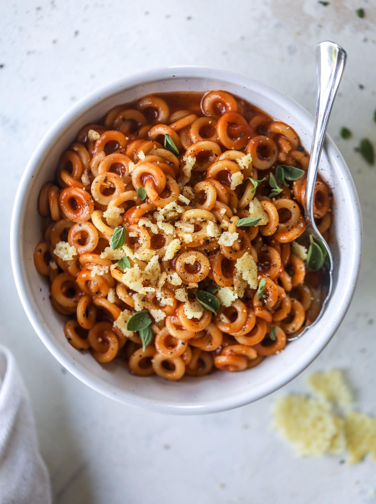 These homemade spaghettios are the ultimate comfort food! They come together in less than 30 minutes, are super easy and flavorful and topped with crispy crunchy manchego cheese that takes the taste over the top! I howsweeteats.com #homemade #spaghettios