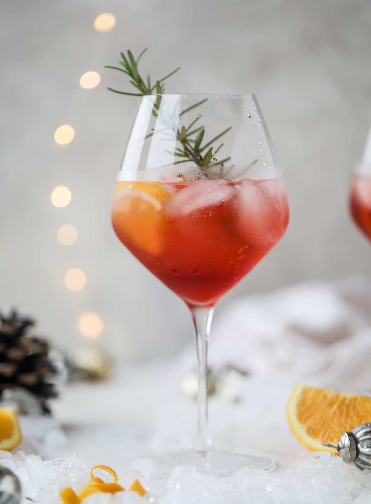This winter aperol spritz cocktail is a seasonal spin on the classic aperol spritz! Festive cranberry and classic orange come together with prosecco and club soda to create a super light and refreshing cocktail for the holidays! I howsweeteats.com #aperol #spritz