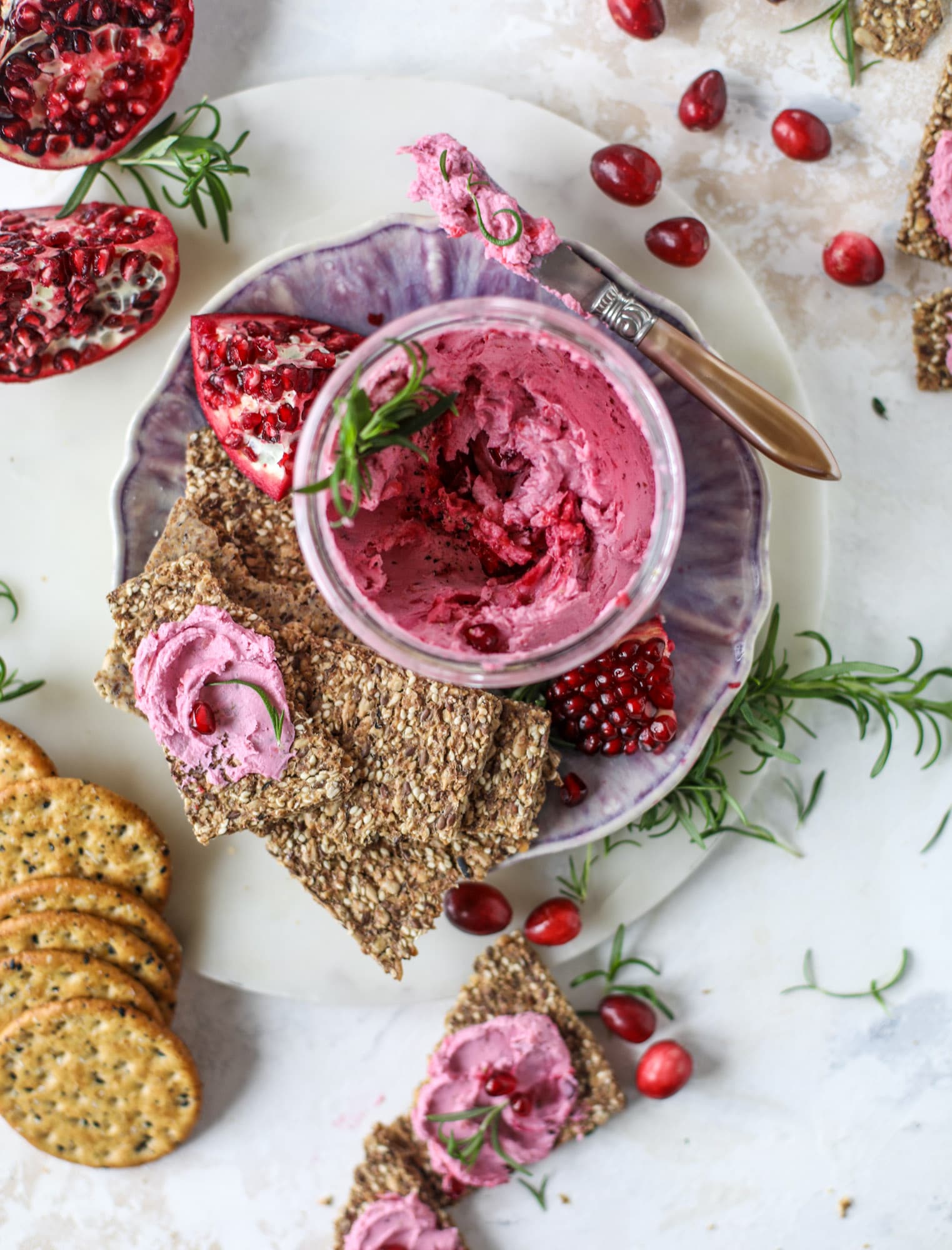 This whipped cranberry goat cheese spread is the perfect holiday appetizer! You can make it ahead of time and serve it with a cheese board or bread and crackers - before or during the meal! Plus it's super pretty too! I howsweeteats.com #cranberry #goatcheese