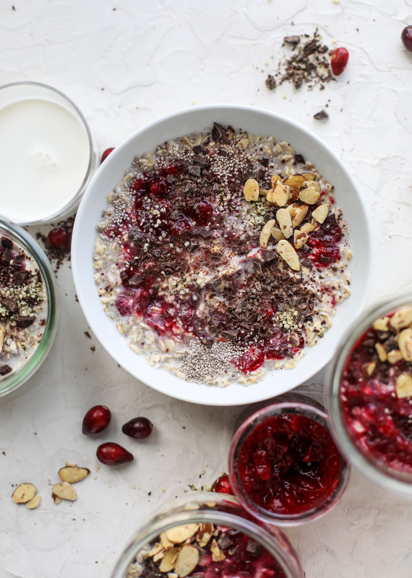 These leftover cranberry overnight oats are the perfect post-Thanksgiving breakfast! Leftover cranberry sauce and dark chocolate come together to flavor chewy, chilled overnight oats. Add on sliced almonds, chia seeds and hemp hearts for more deliciousness! I howsweeteats.com #overnight #oats