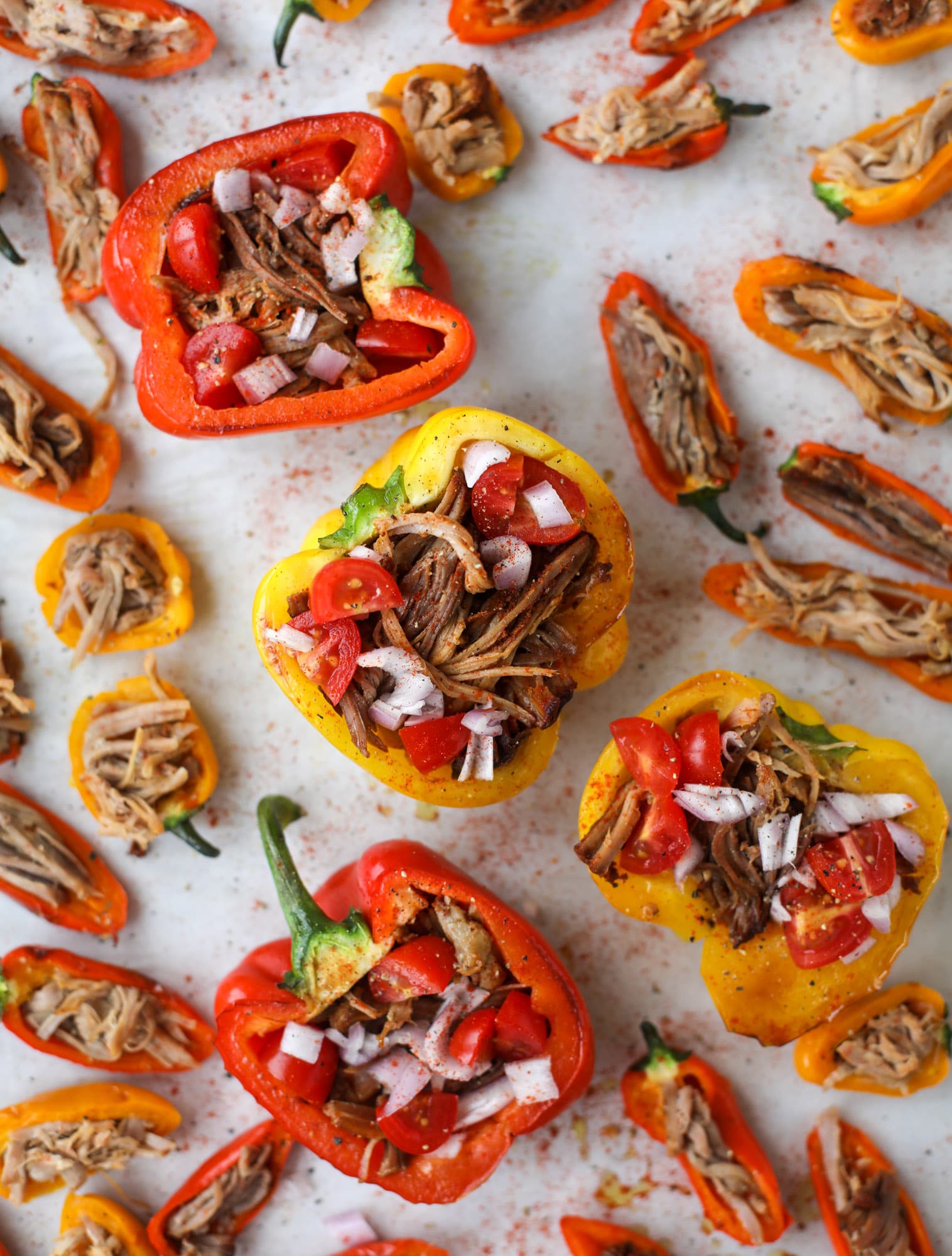These pulled pork stuffed peppers are a delicious dinner idea for any weeknight! They work great with leftover pulled pork and the filling is totally customizable. They are flavorful, come together quickly and always a crowd pleaser! I howsweeteats.com #pulledpork #stuffedpeppers