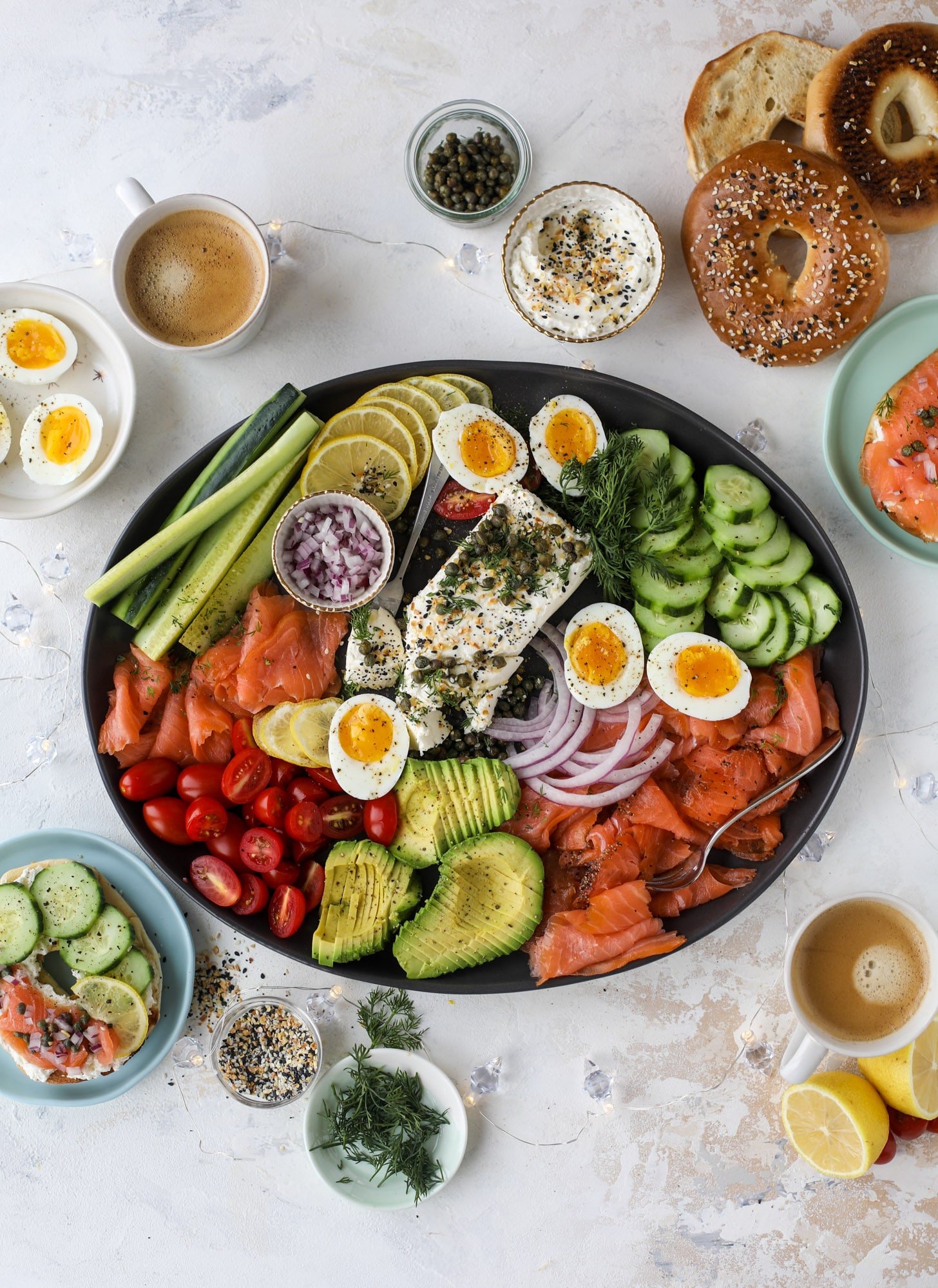 This is my favorite way to make an incredible smoked salmon platter! Fresh smoked salmon with bagels, soft boiled eggs, cream cheese and capers, everything seasoning and so much more. Perfect for holiday breakfasts and brunches! I howsweeteats.com #smokedsalmon #platter