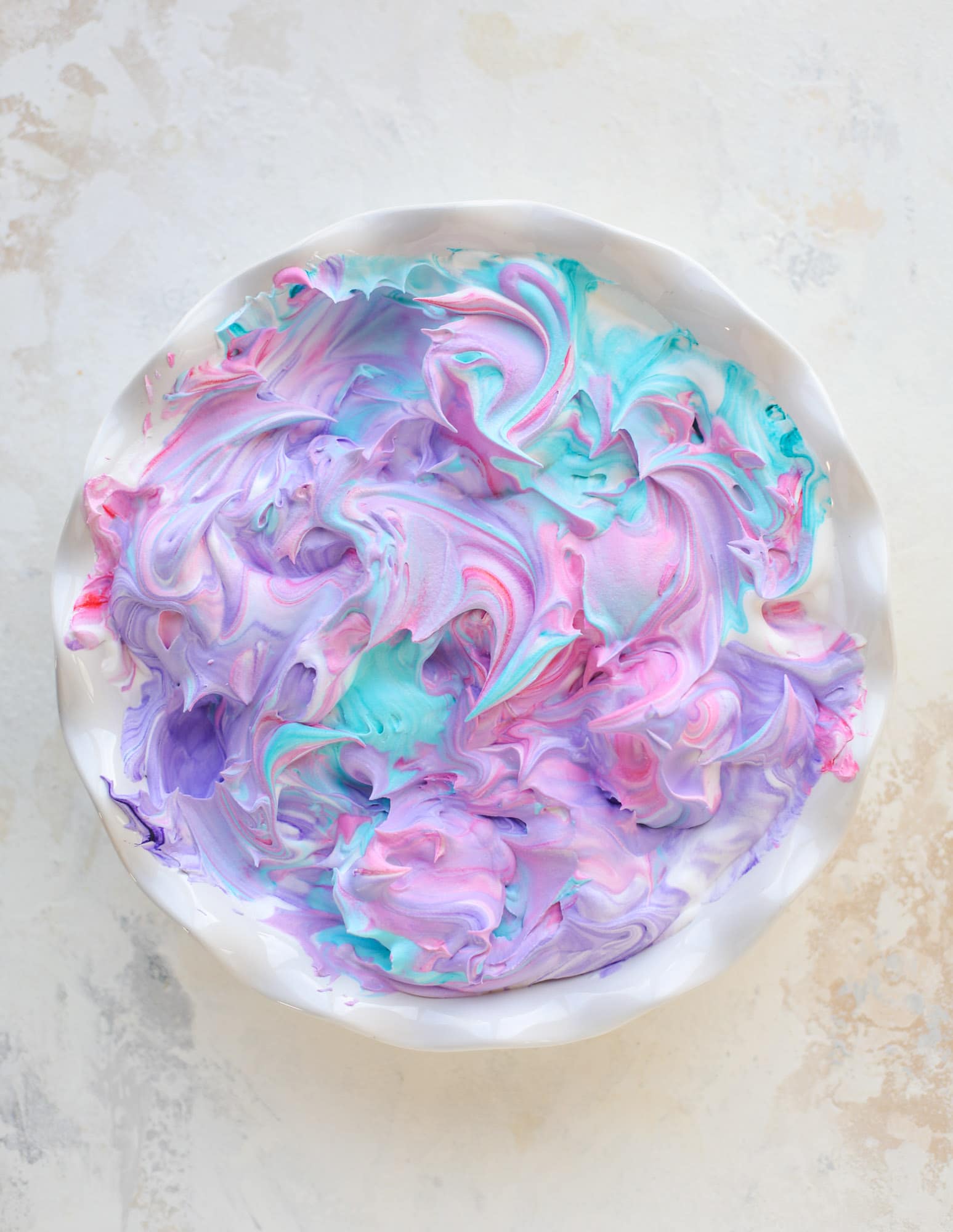 This is how to dye eggs with cool whip! It's so fun, super kid-friendly and ridiculously easy too. I love using this method to make unicorn eggs!