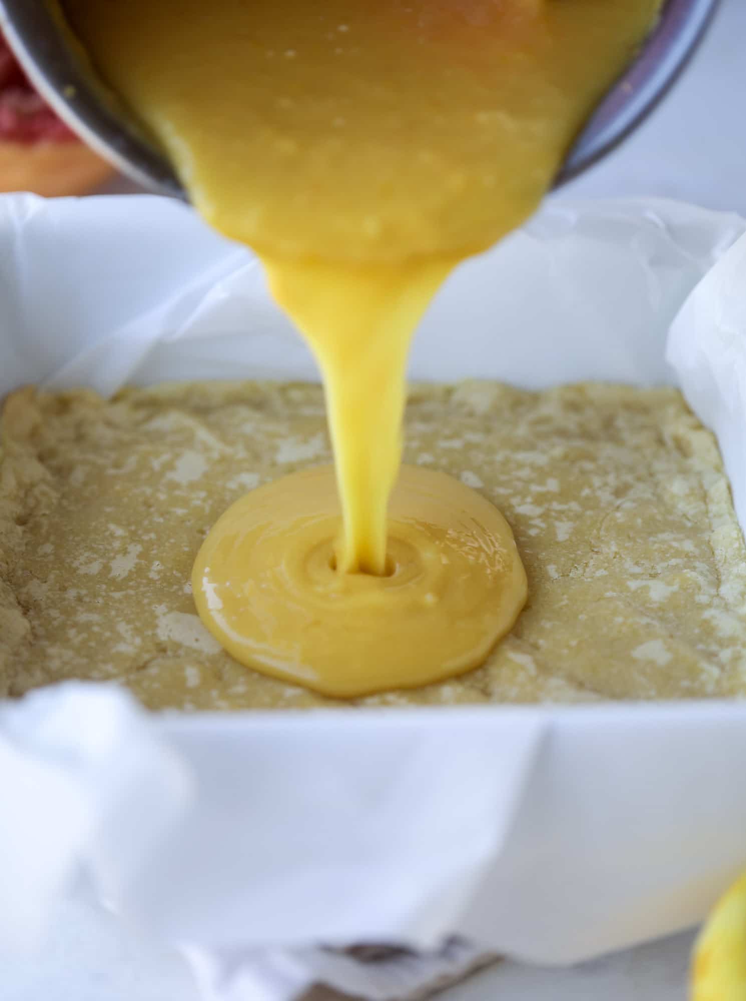 pouring curd into shortbread crust