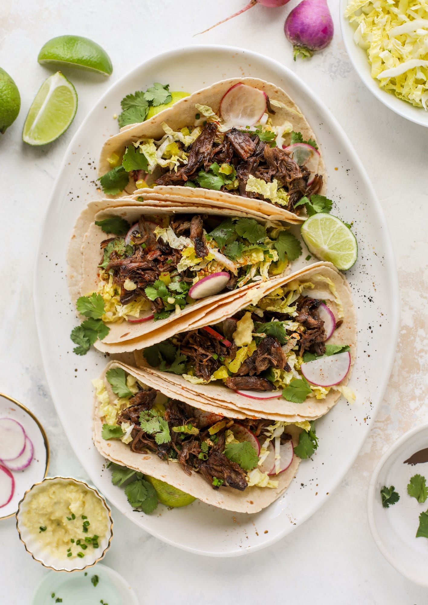 These are the best smoky short rib tacos made in the slow cooker! Served with a banana pepper mustard and napa cabbage slaw, it's a flavor explosion.