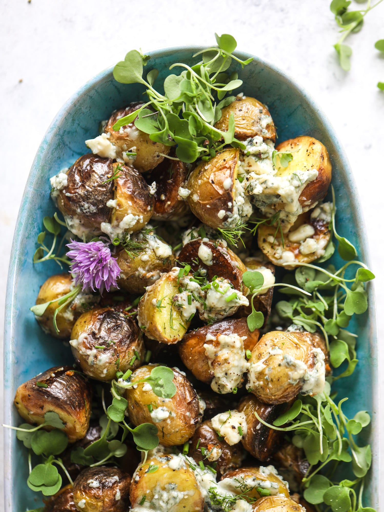These grilled gorgonzola potatoes are loaded with flavor! Crispy, crunchy grilled bab golds topped with creamy blue cheese and fresh herbs.