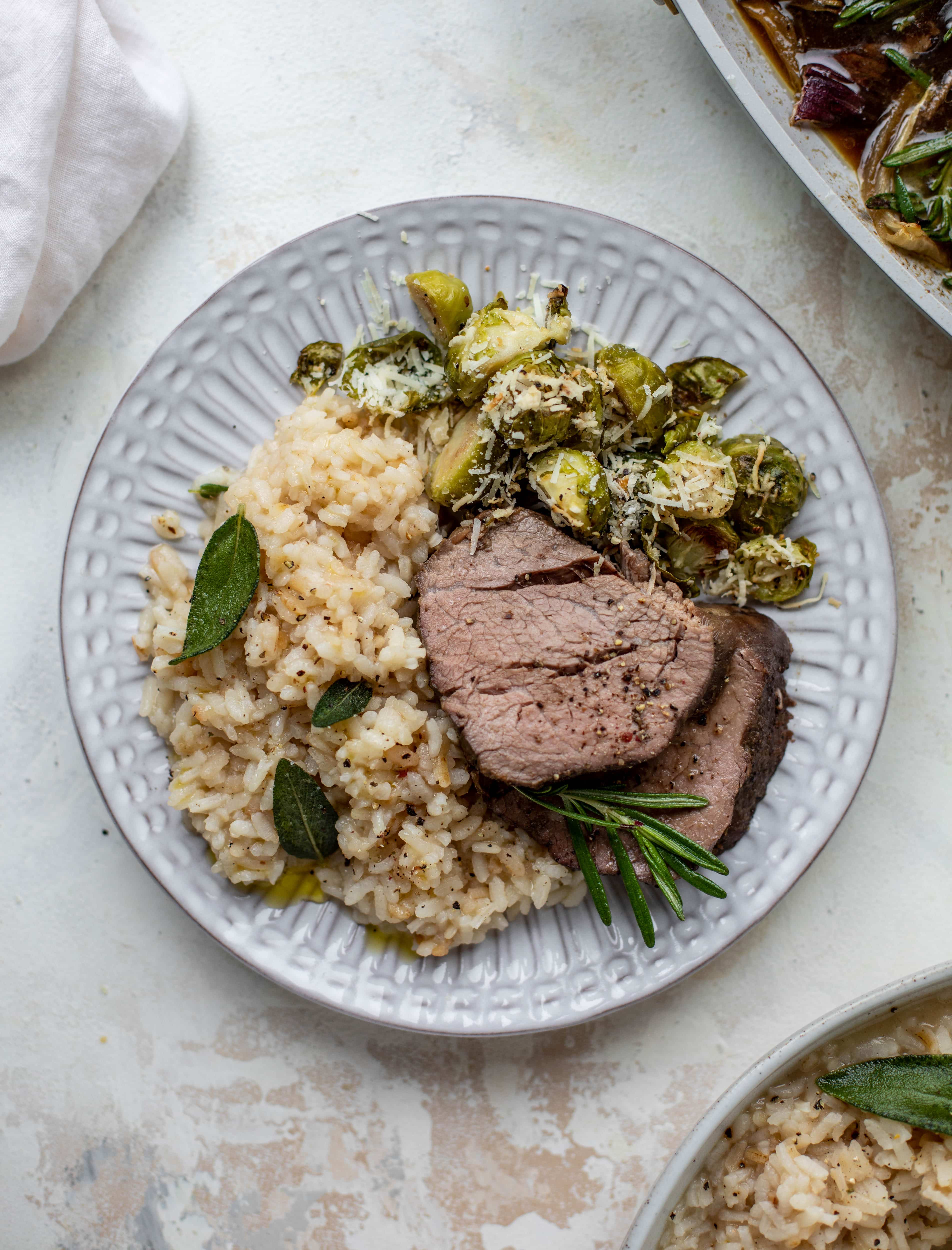 The ultimate special occasion meal! Espresso crusted filet paired with truffle sage risotto and cacio e pepe brussels. So much flavor - it's perfect for the holidays!