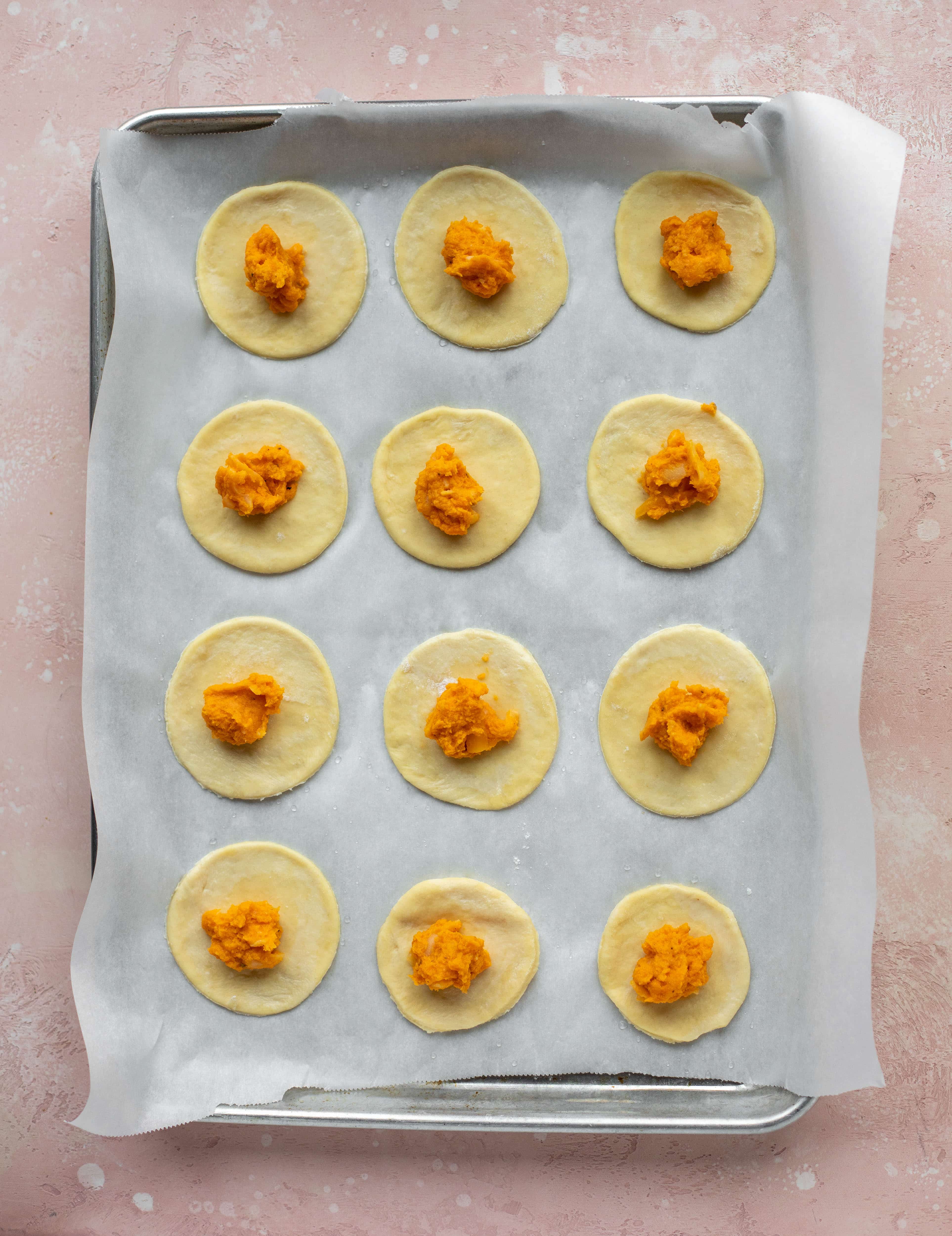 The most delicious sweet potato pierogi recipe! Roasted sweet potato and fontina cheese in pillowy dough. Make sure to serve with brown butter!