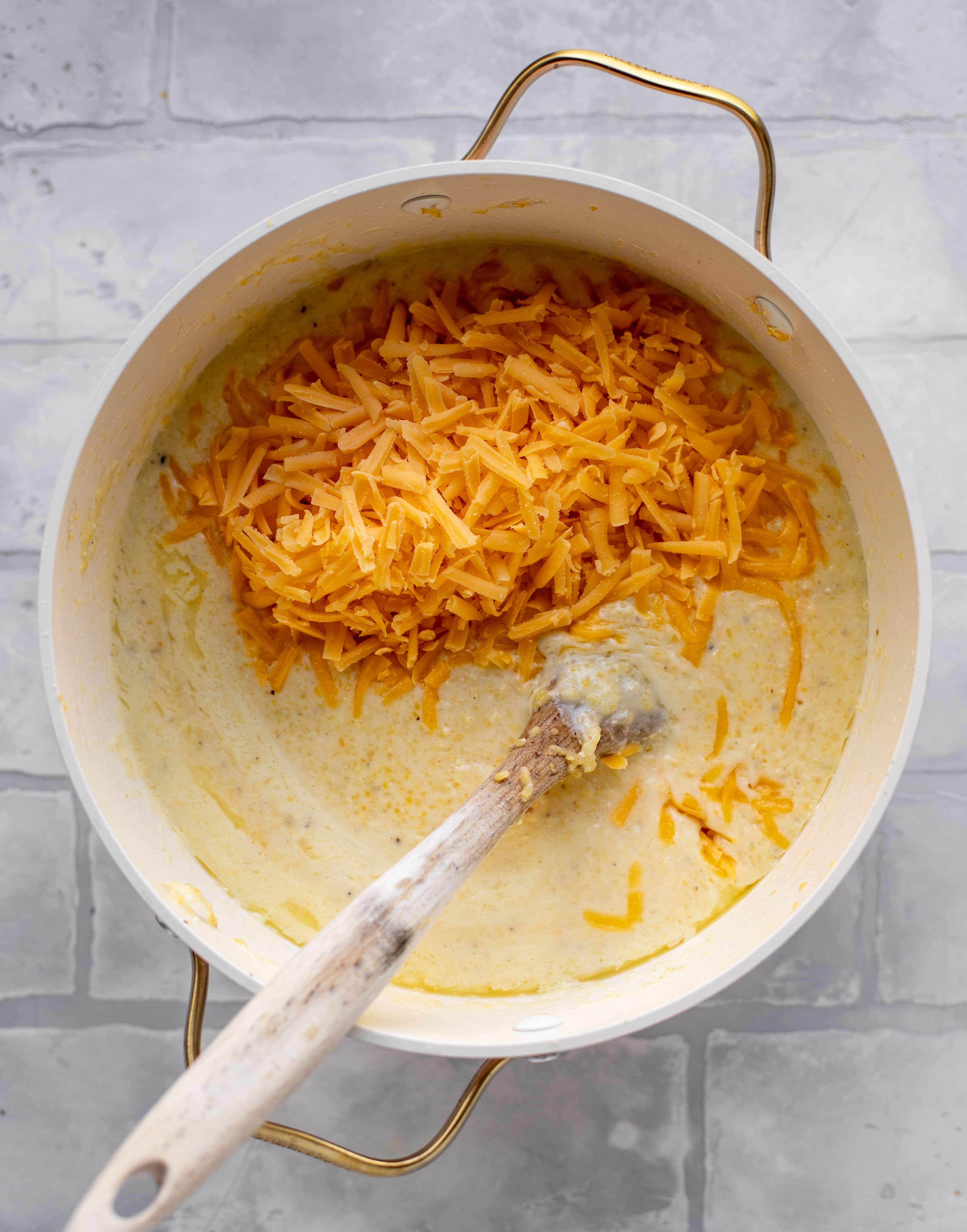 pot of grits with grated cheddar