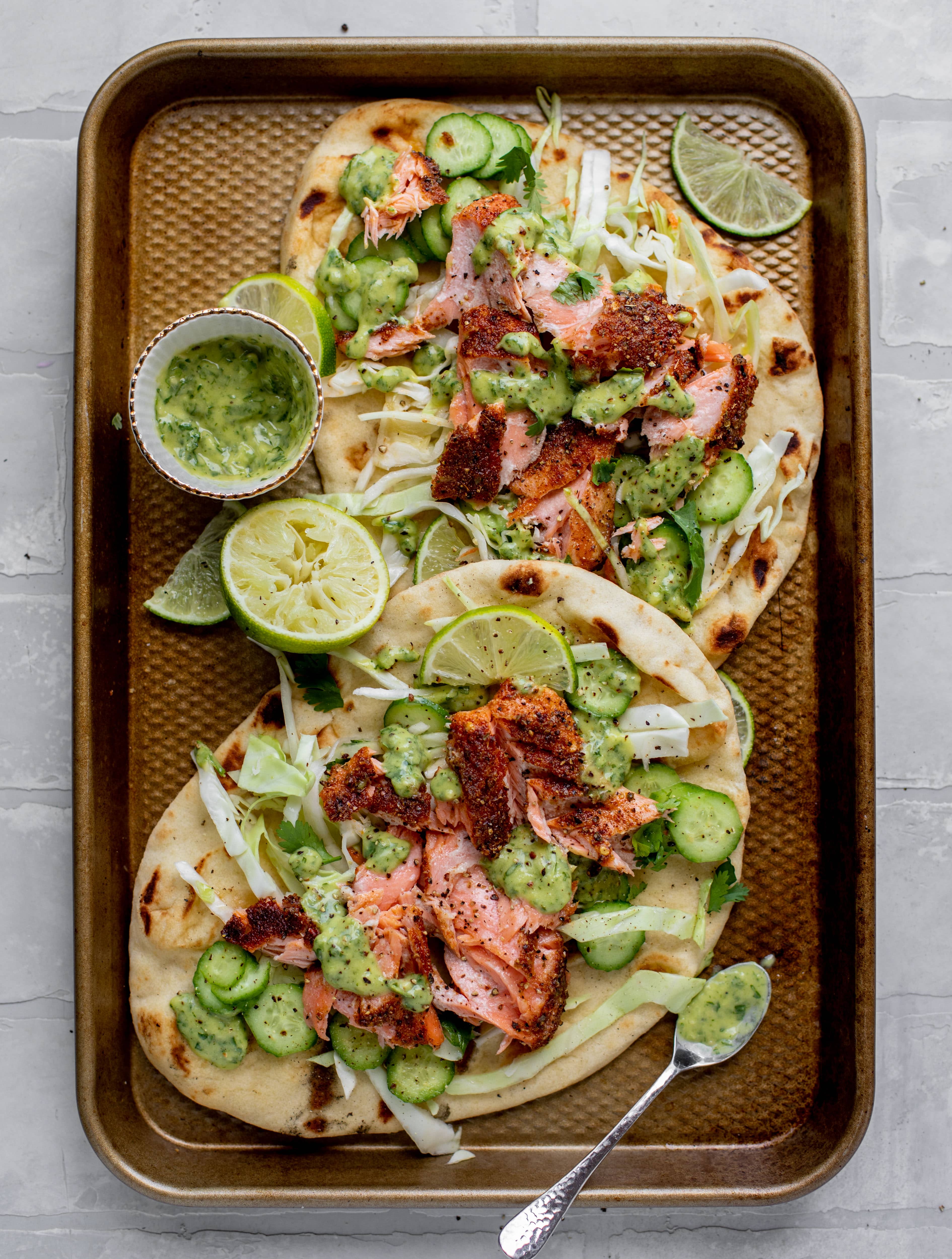 grilled salmon on naan bread with slaw and cilantro sauce