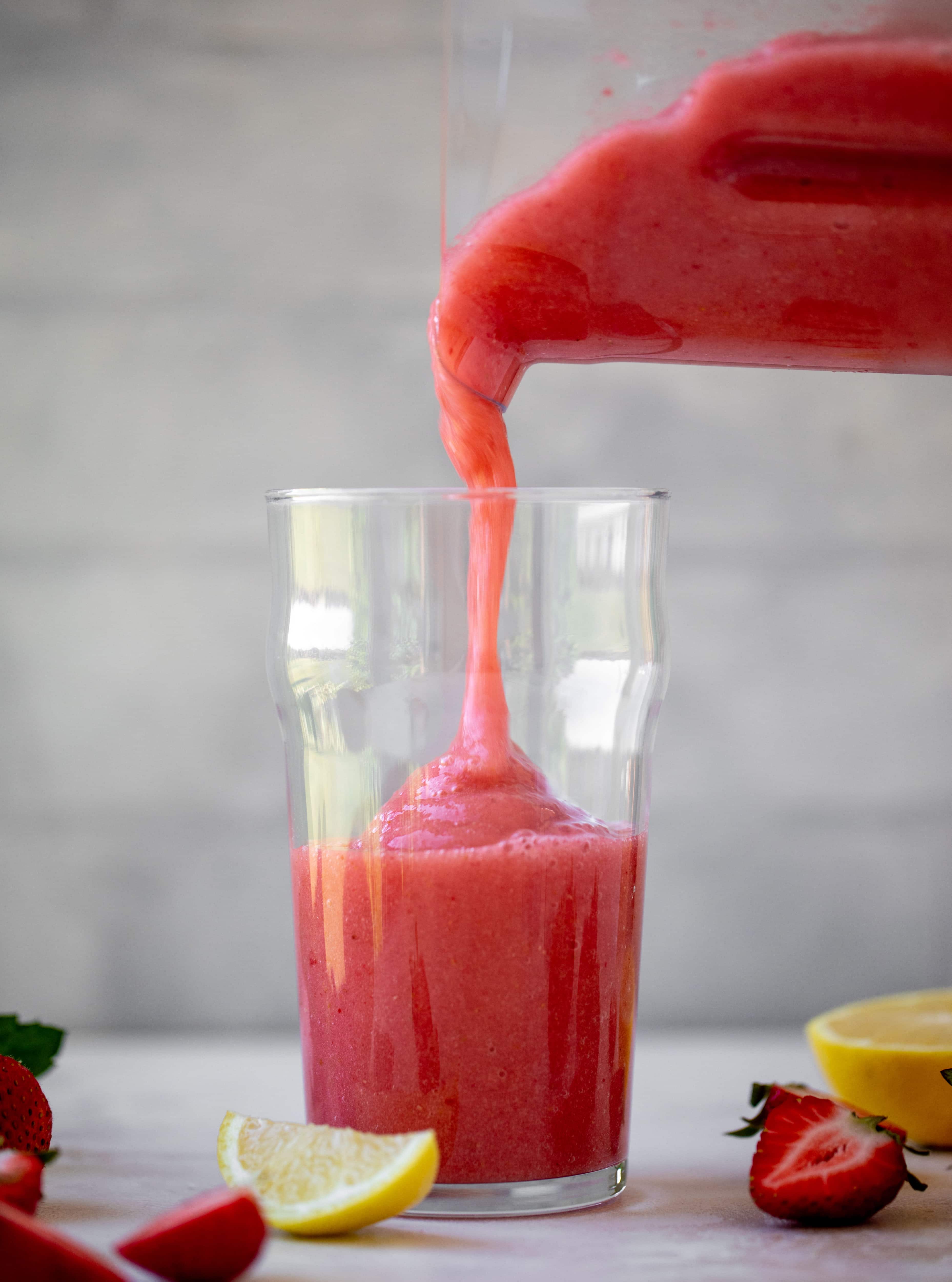 pouring frozen strawberry lemonade