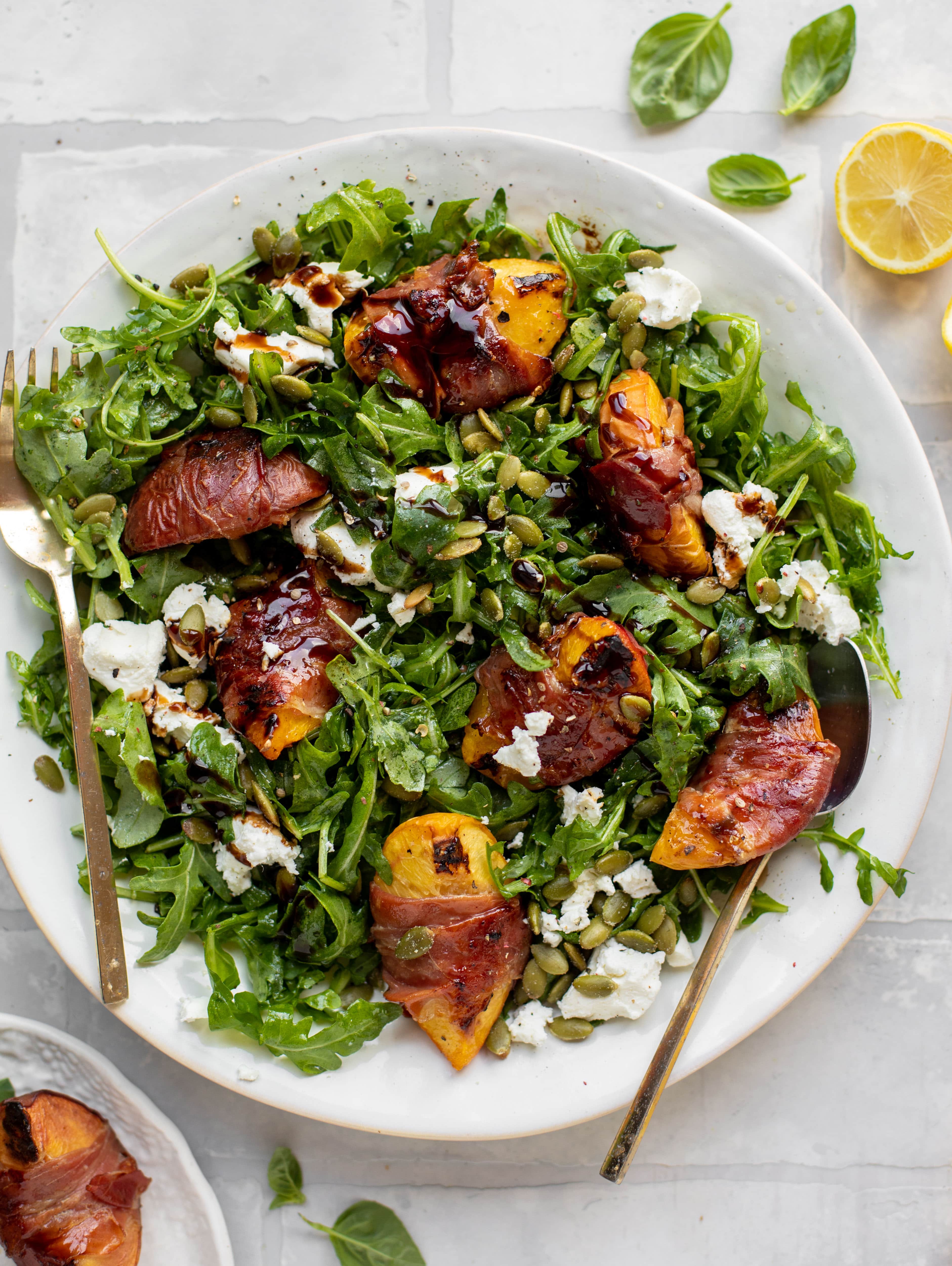 grilled prosciutto wrapped peaches with arugula and goat cheese