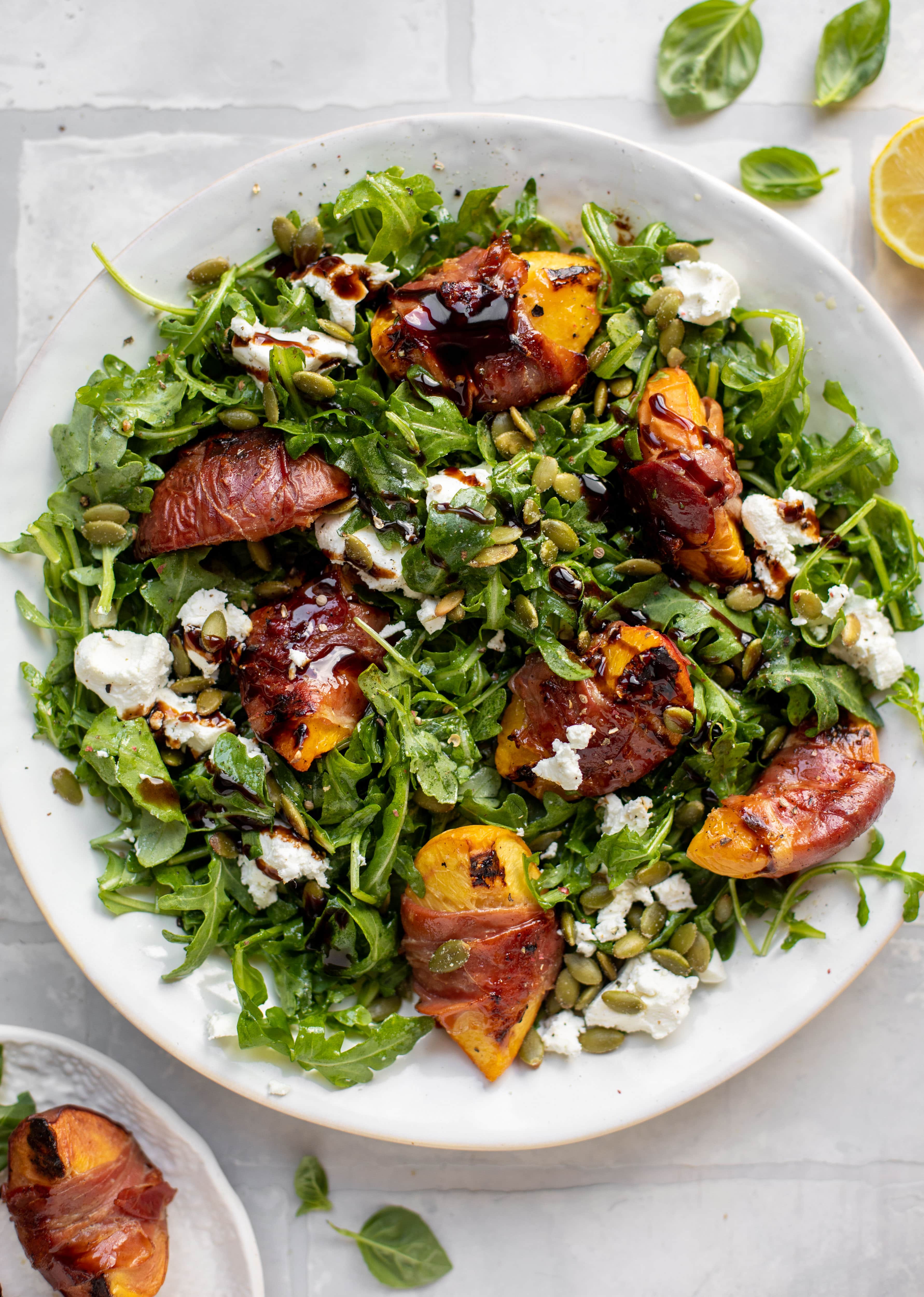 grilled prosciutto wrapped peaches with arugula and goat cheese