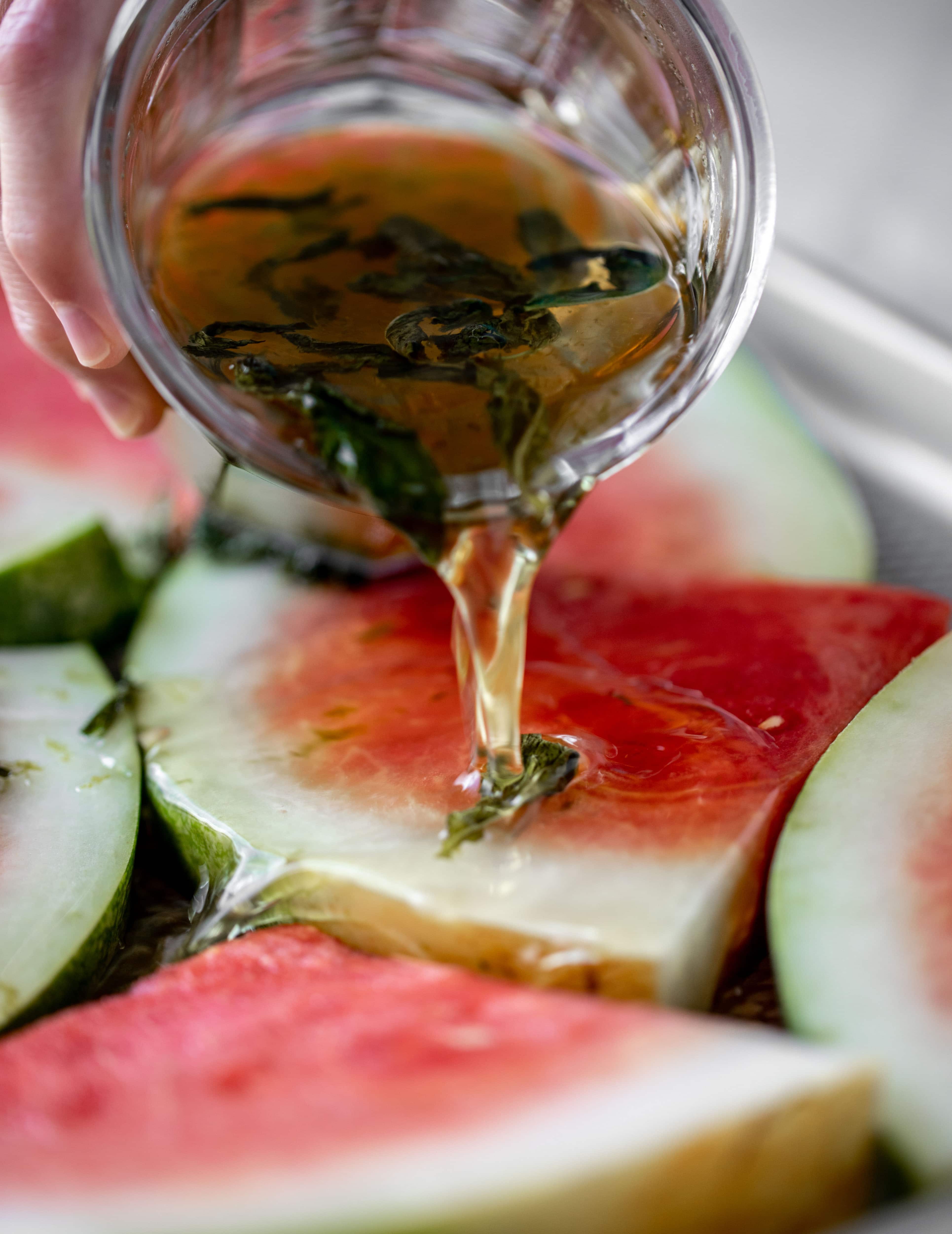 pouring mojito syrup on watermelon