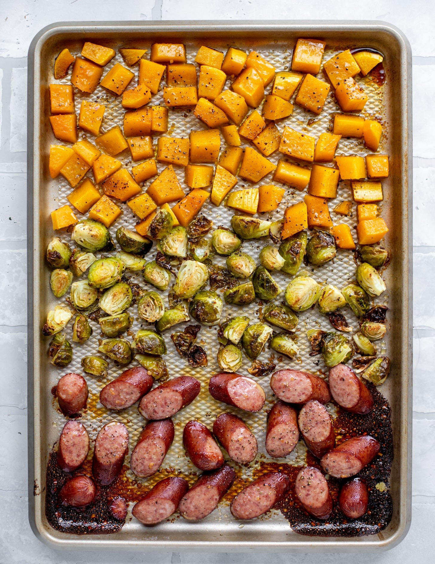maple sheet pan smoked turkey sausage with butternut squash and brussels sprouts just out of the oven