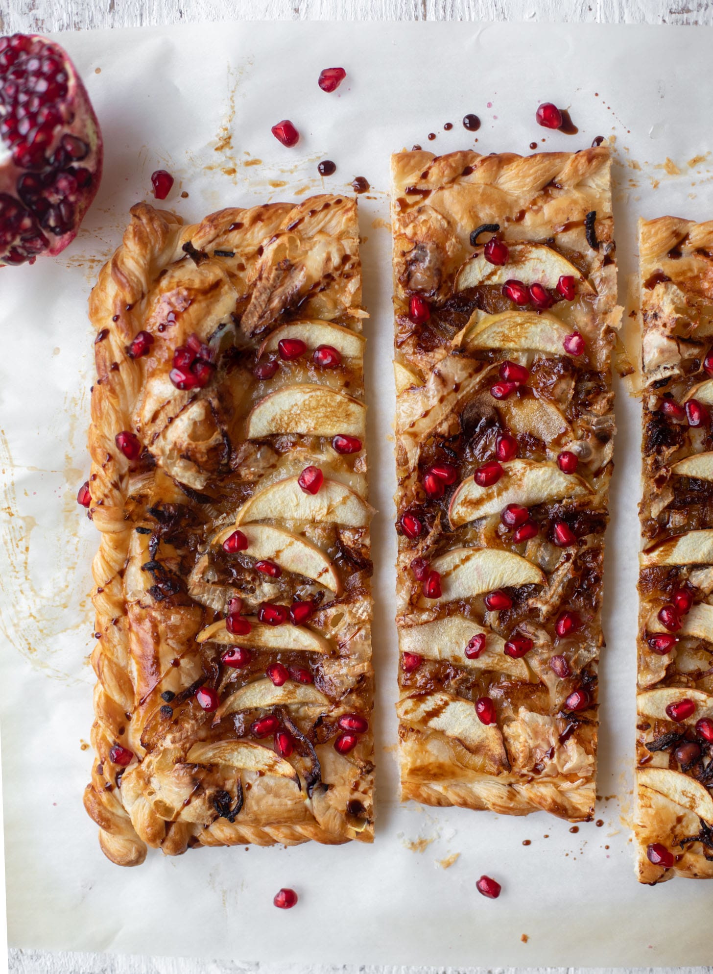 caramelized onion, apple and brie puff pastry tart with pomegranate molasses