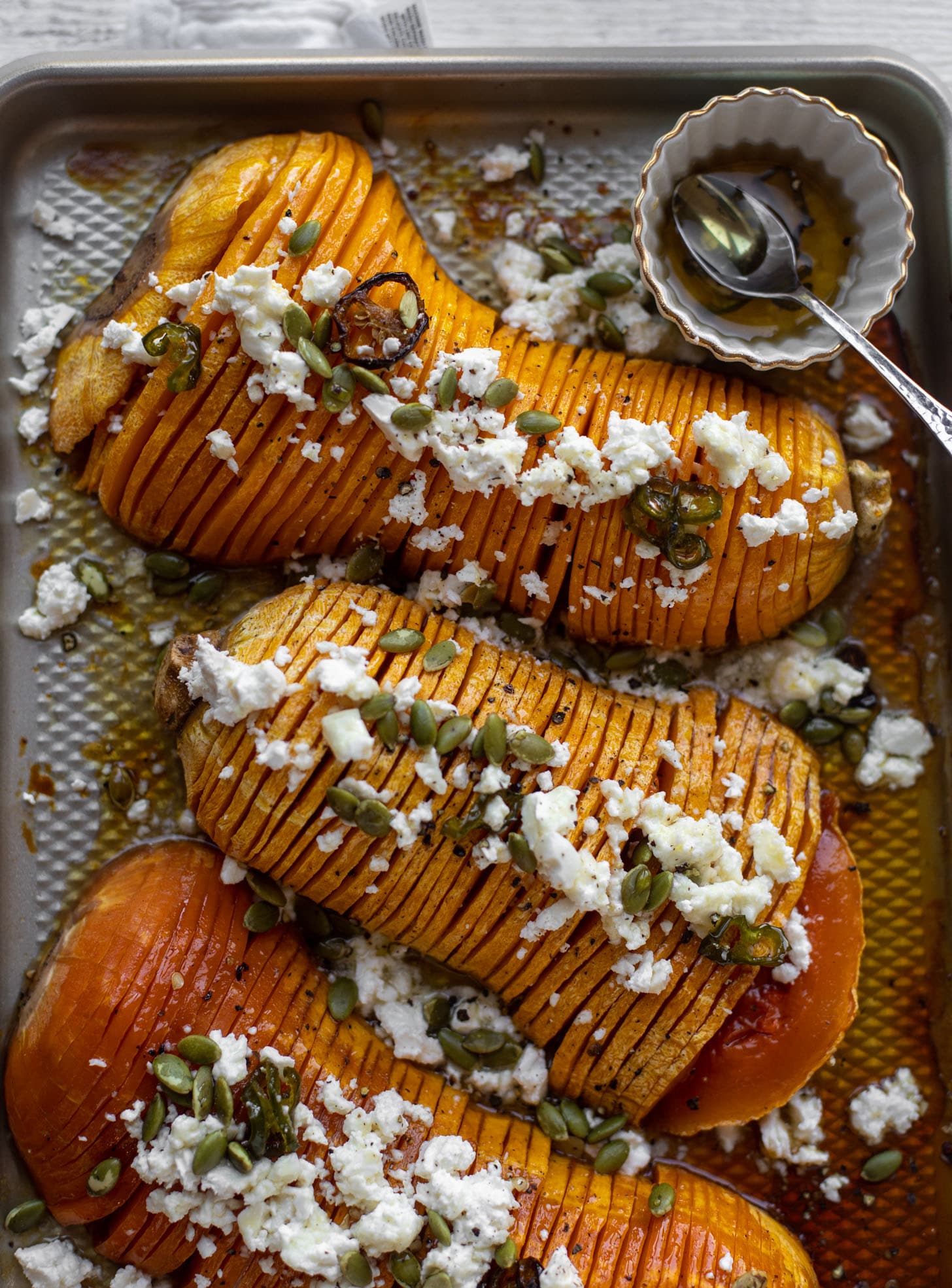 hot honey hasselback butternut squash with feta and pepitas