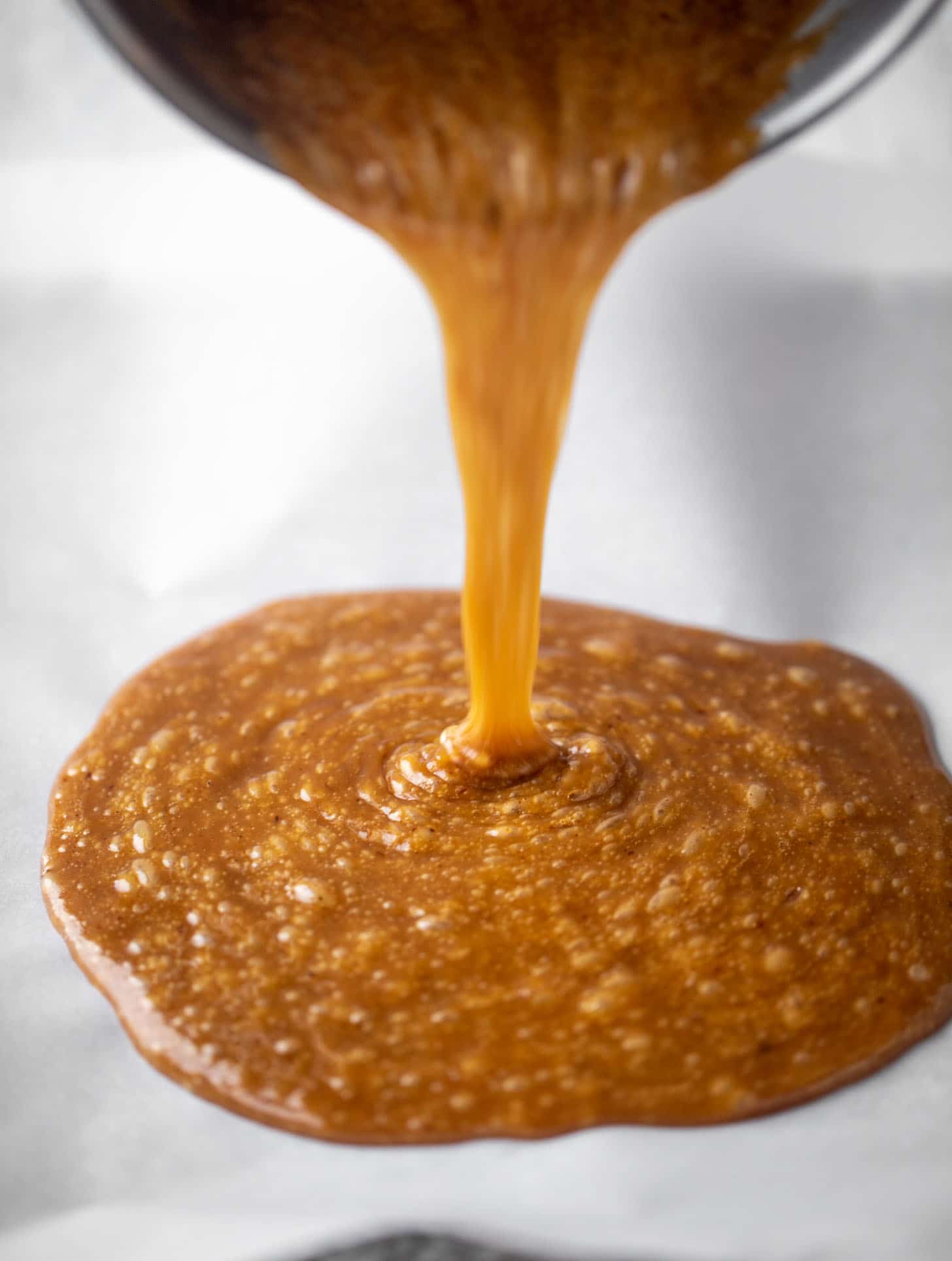 pouring toffee onto pan
