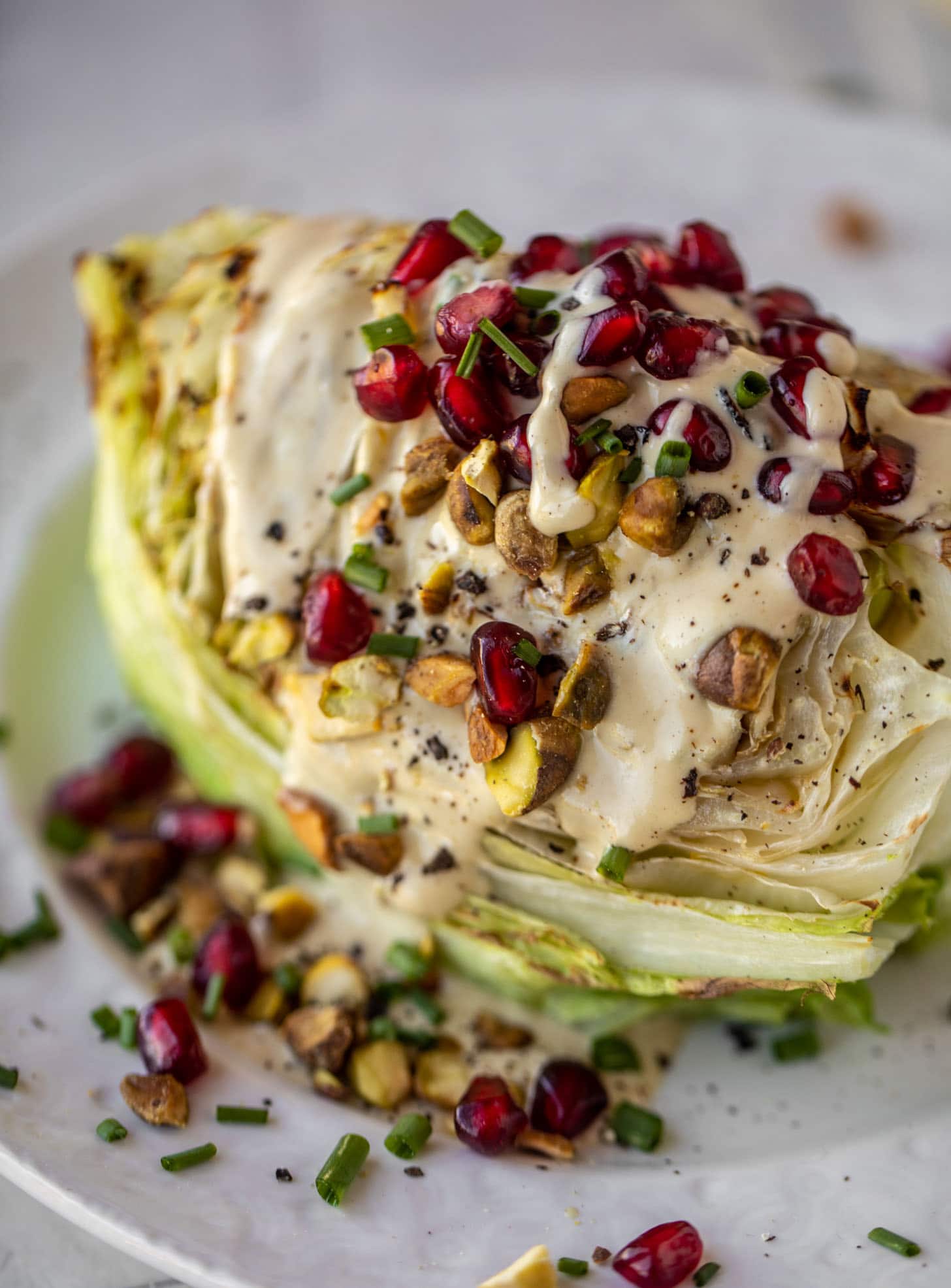 broiled wedge salad with pomegranates and pistachios