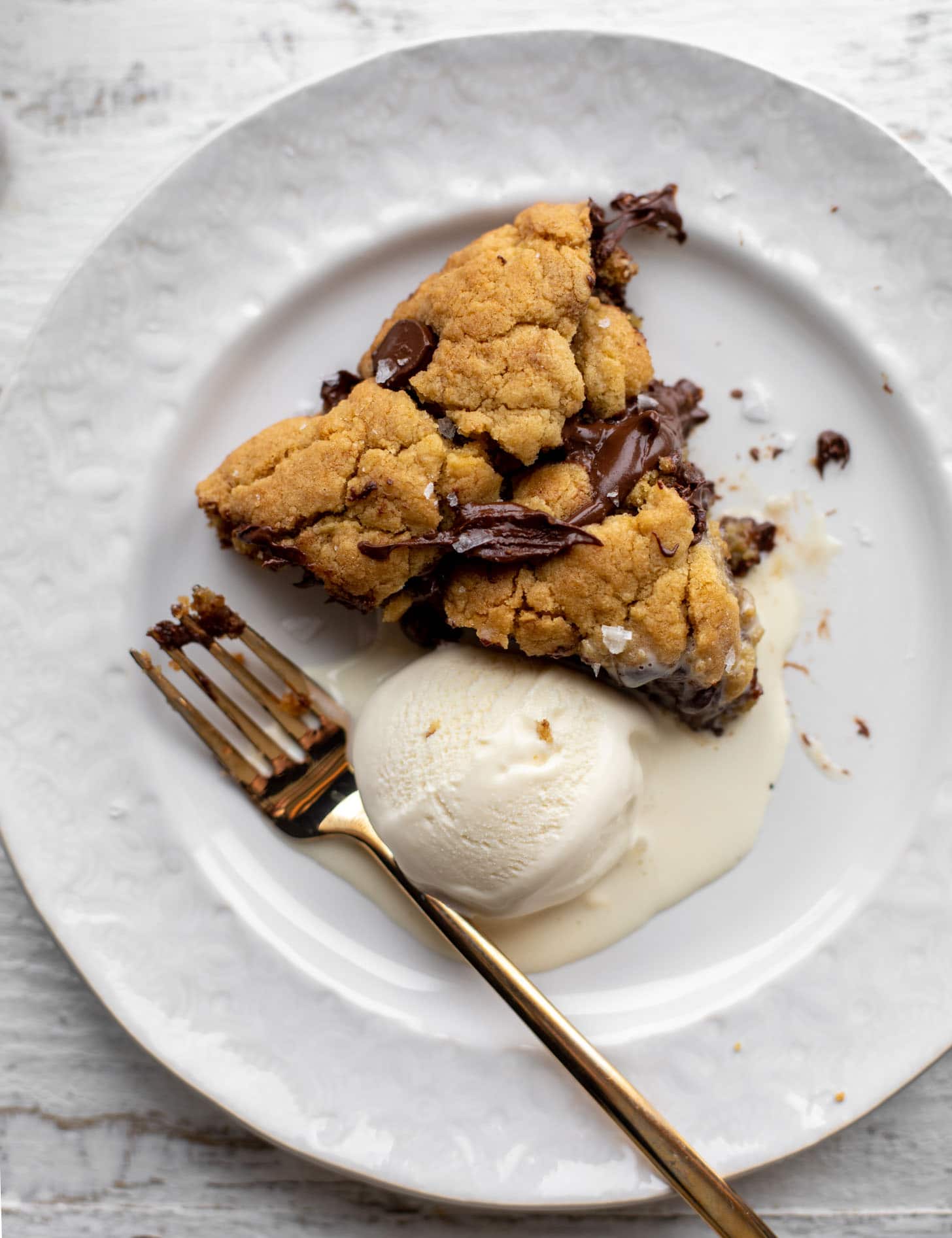 slice of chewy chocolate chip skillet cookie with ice cream
