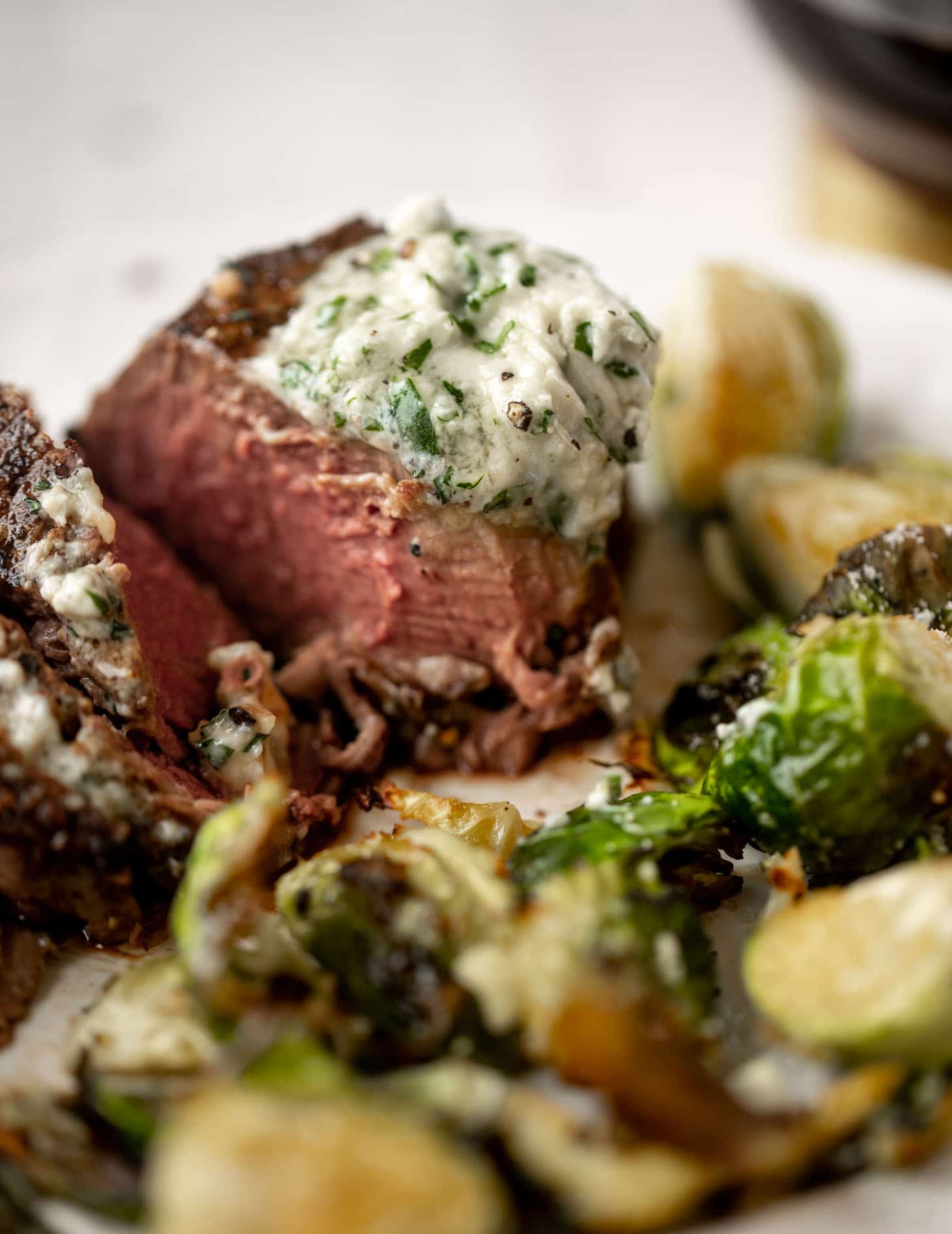 filet mignon with blue cheese butter and cacio e pepe brussels