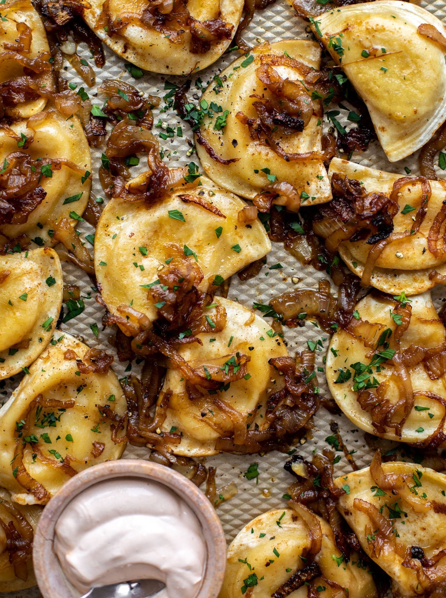 sheet pan pierogies with caramelized onions and chipotle sour cream