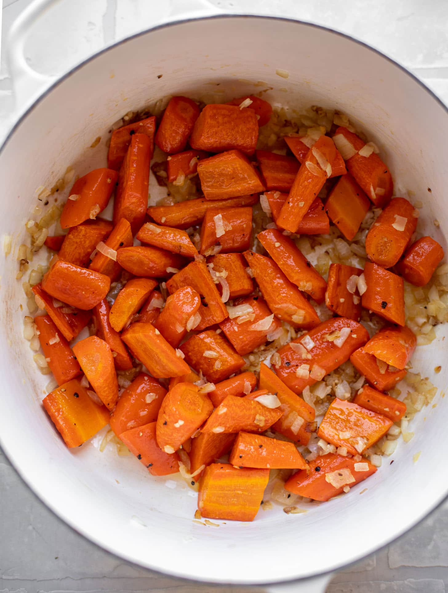 roasted carrots in a pot with sautéed onions