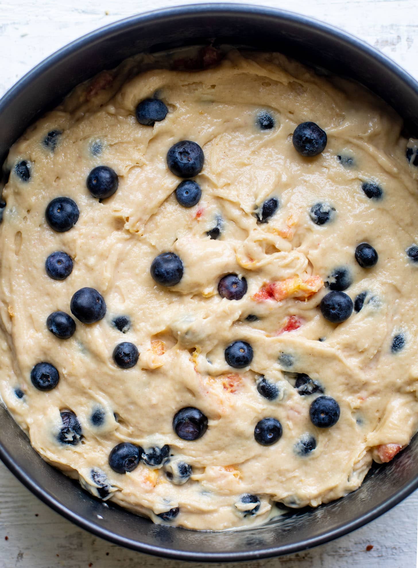 cake batter with blueberries and peaches