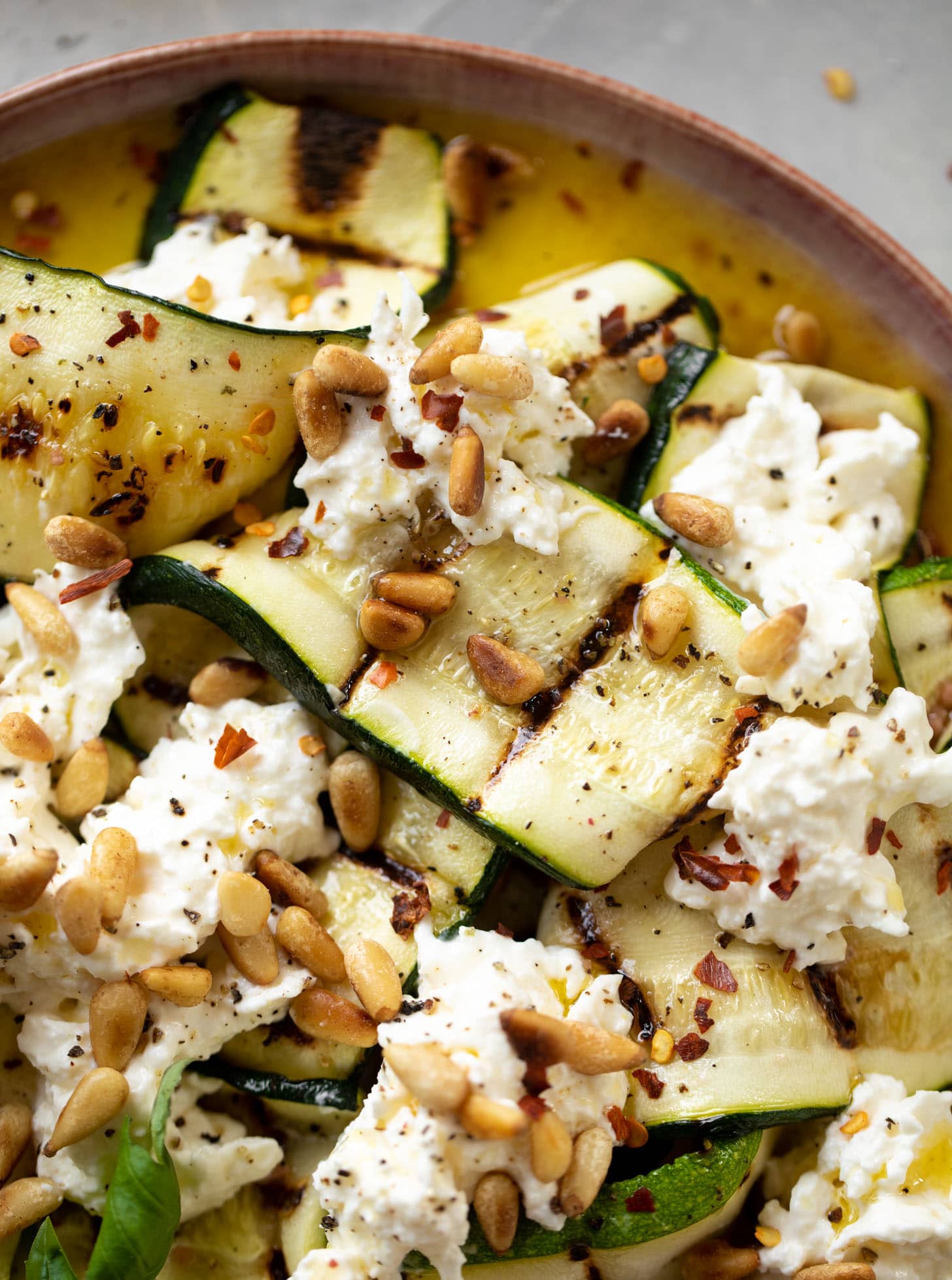 grilled zucchini with burrata and pine nuts