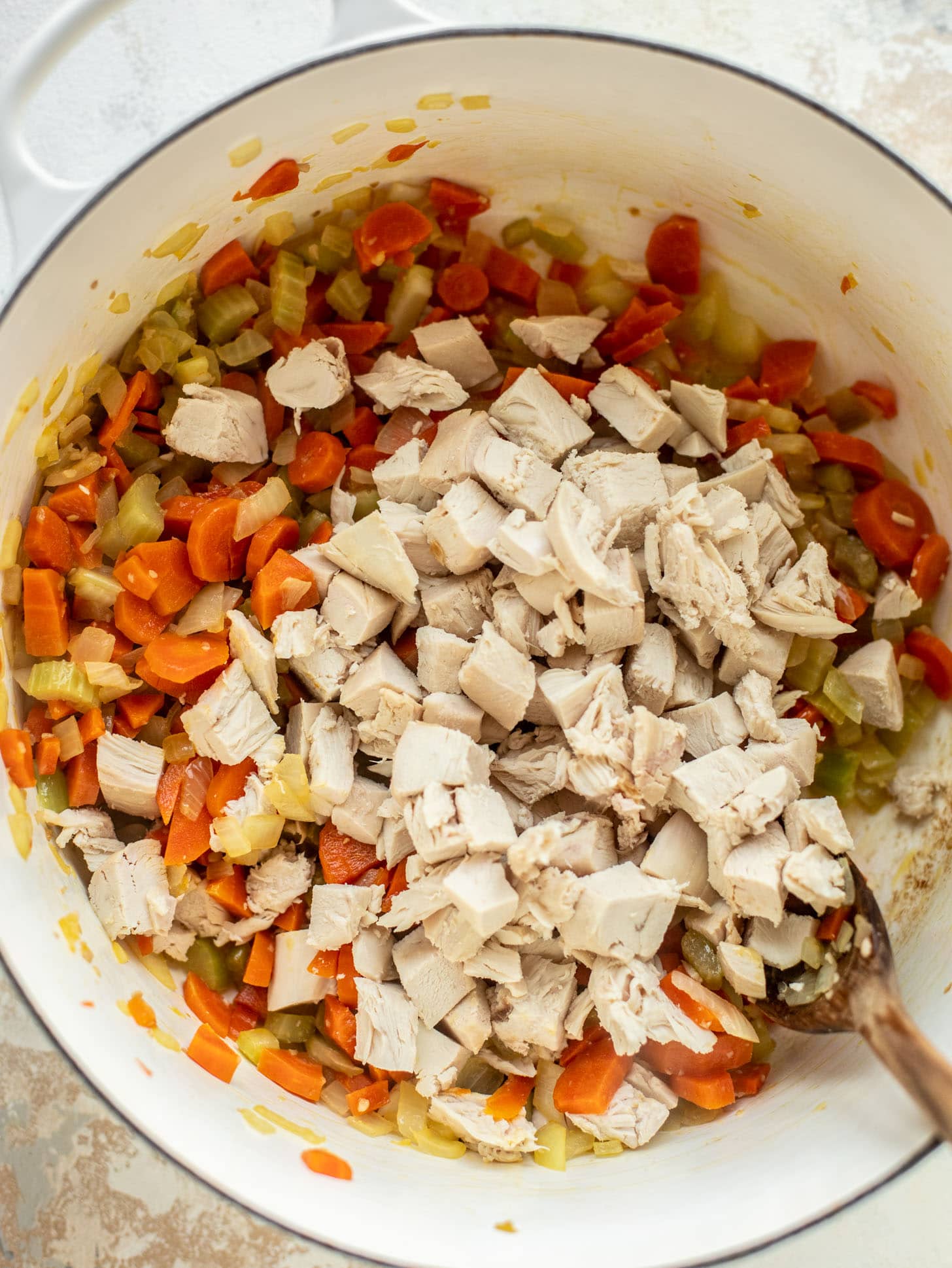 celery, onions, carrots, ginger, garlic and chicken in a pot