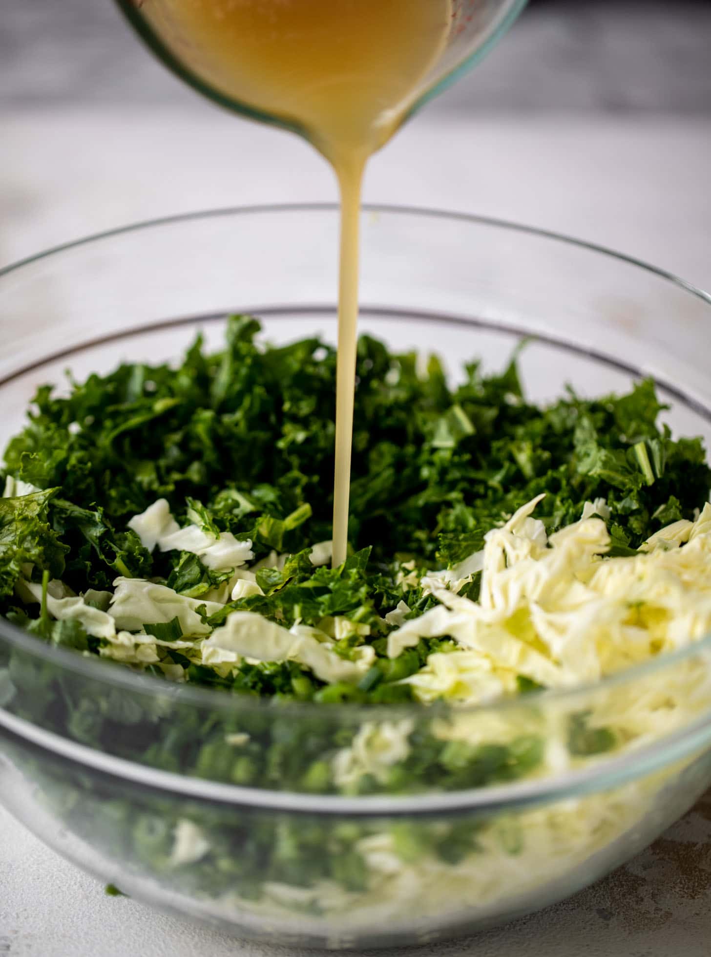 pouring dressing on salad