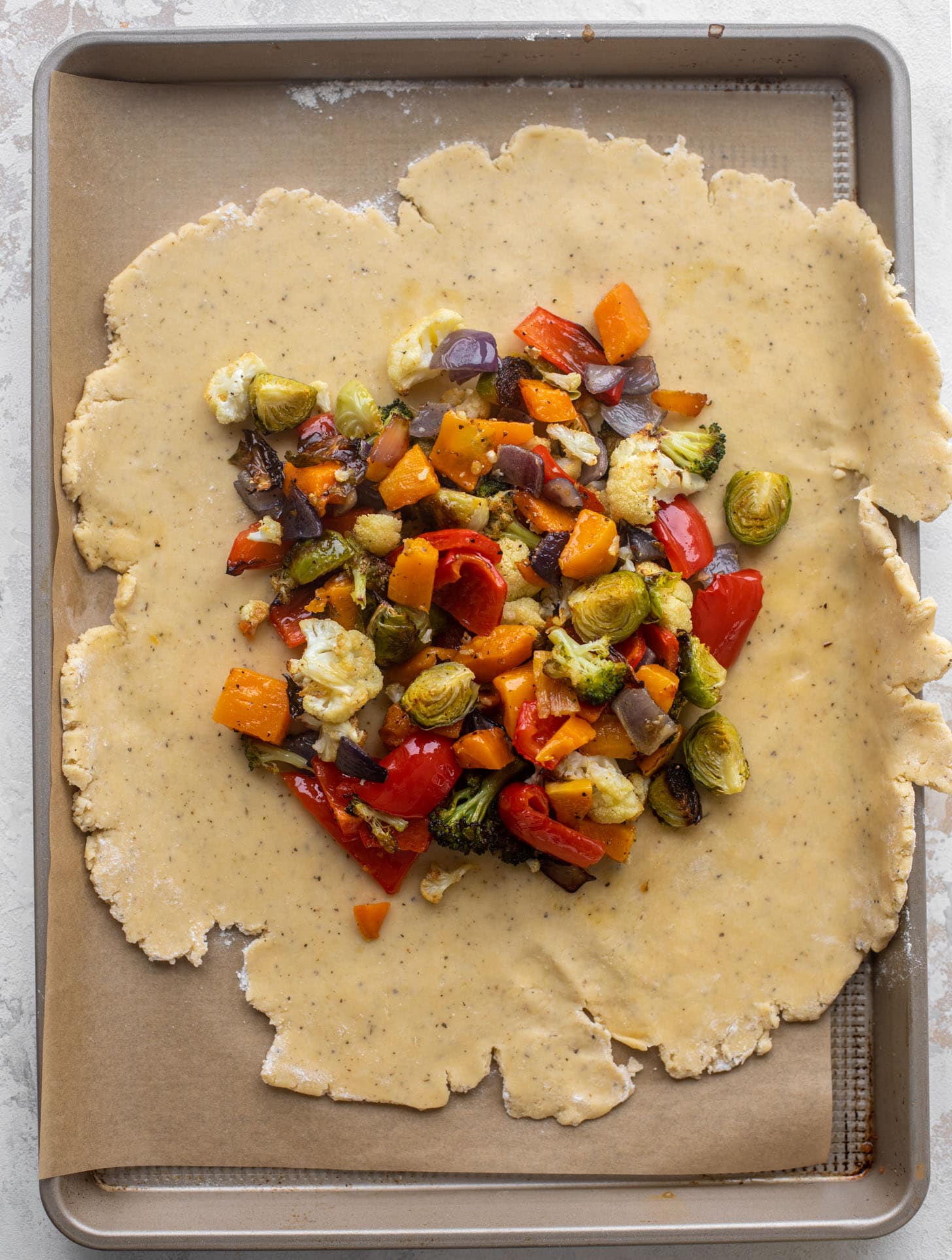 pie dough topped with roasted vegetables