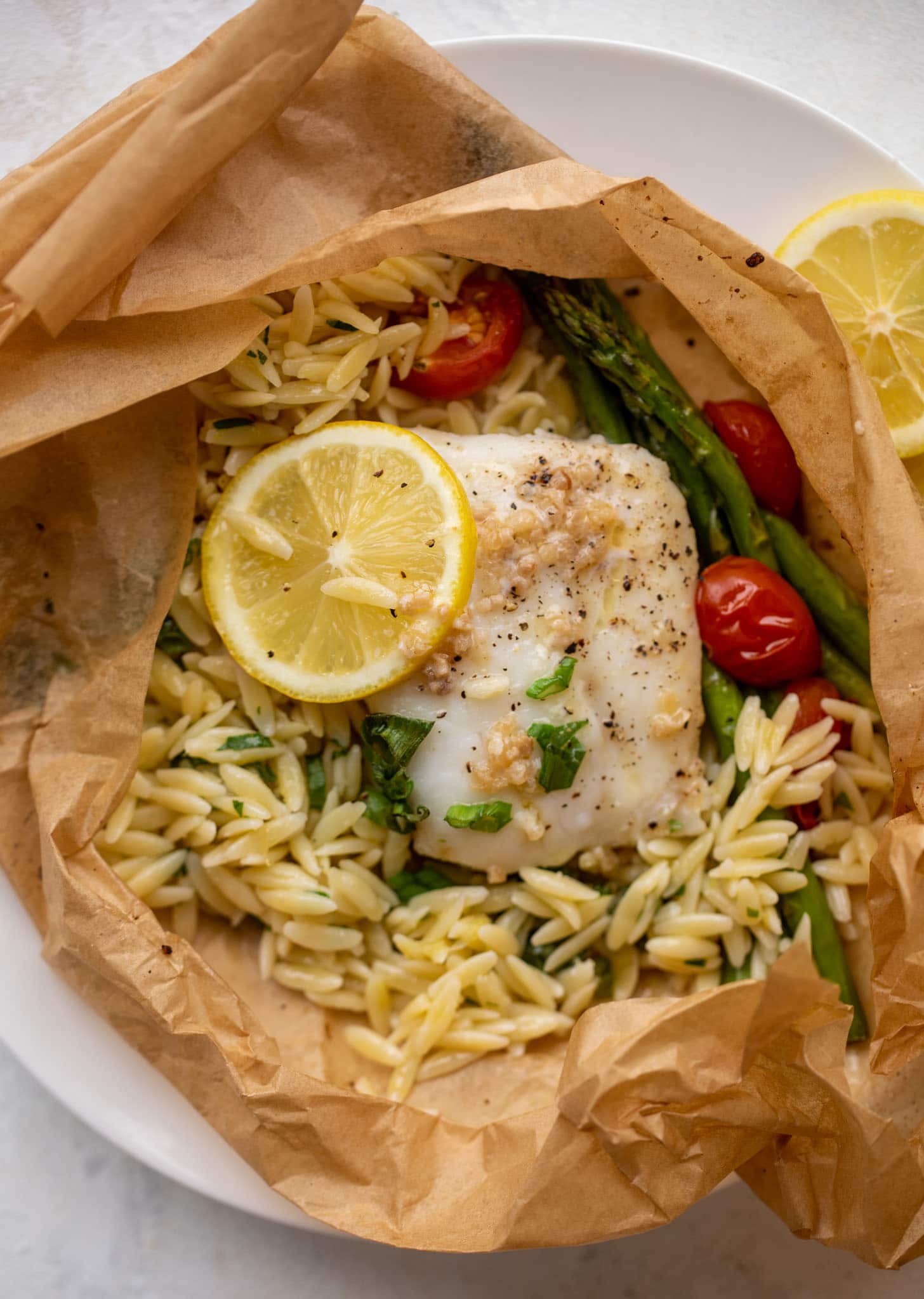 lemon garlic butter orzo and fish in parchment packet