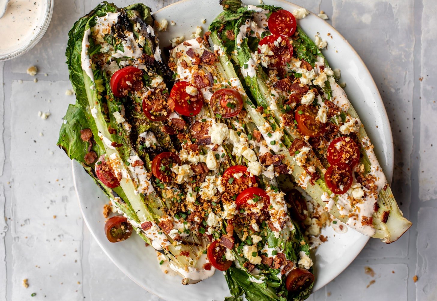 grilled romaine salads with tomatoes, bacon and ranch