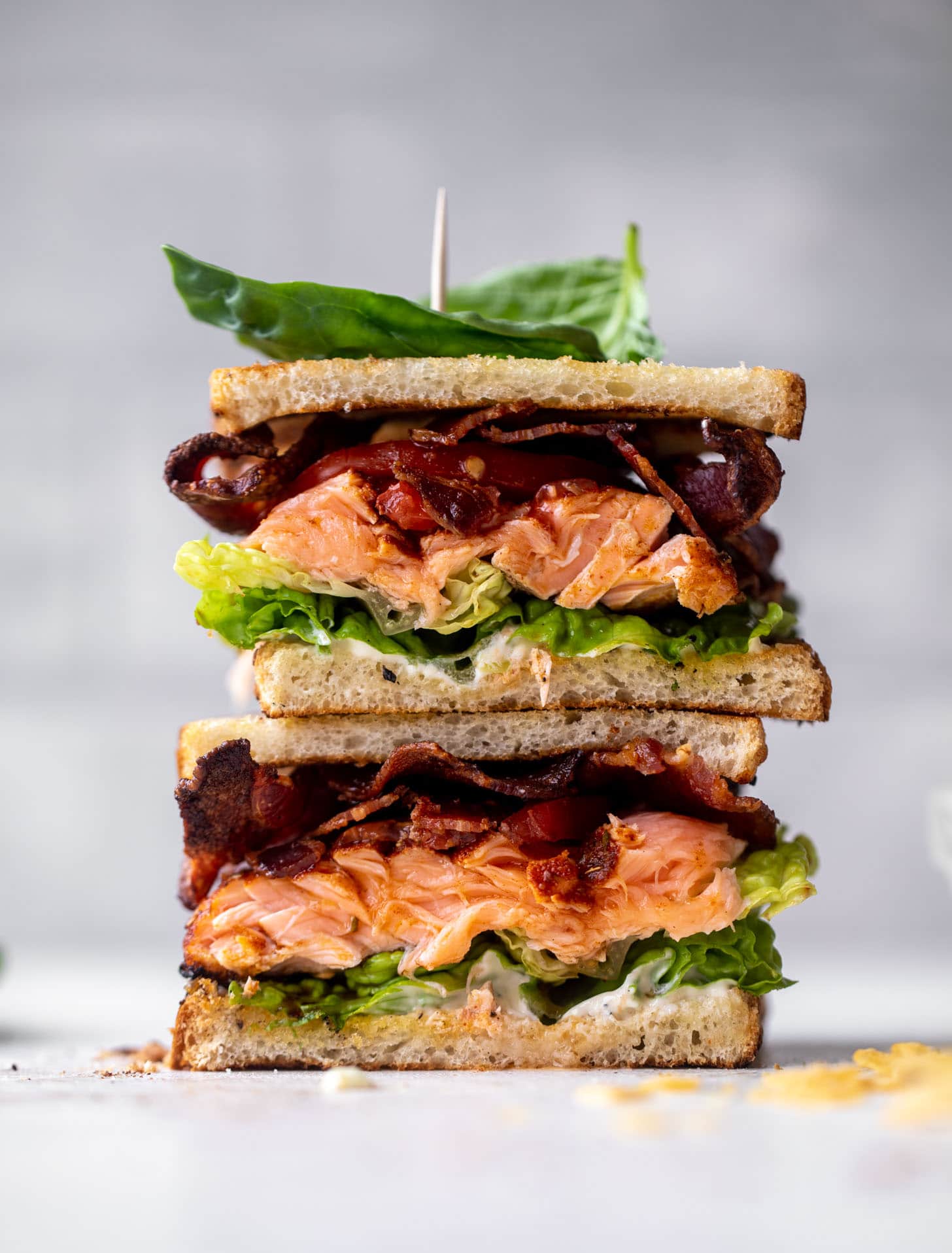 salmon club sandwich with charred scallion mayo