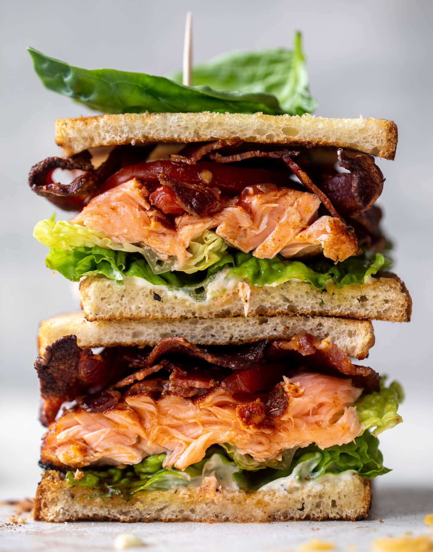 salmon club sandwich with charred scallion mayo