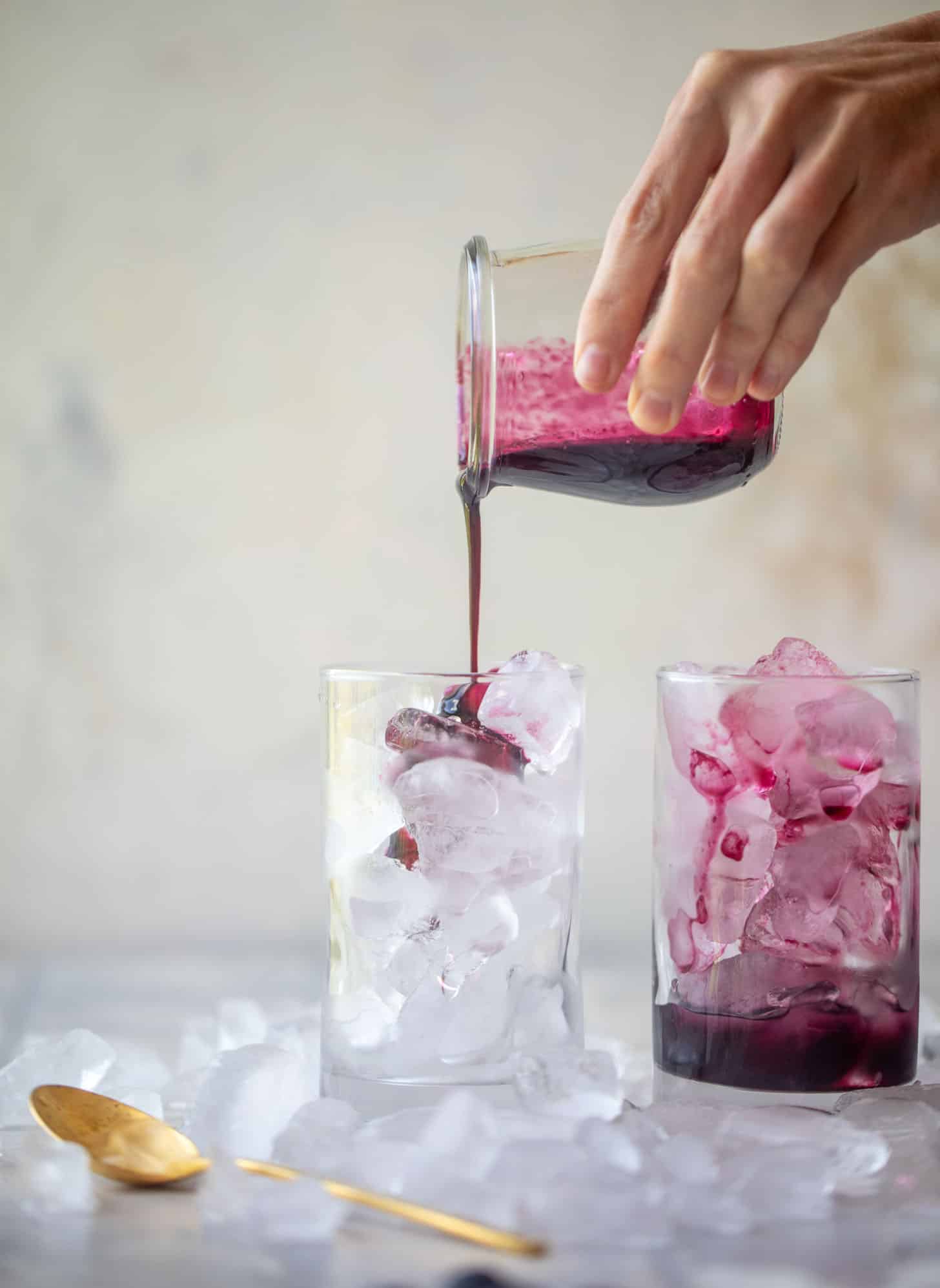 pouring blueberry lavender syrup over ice